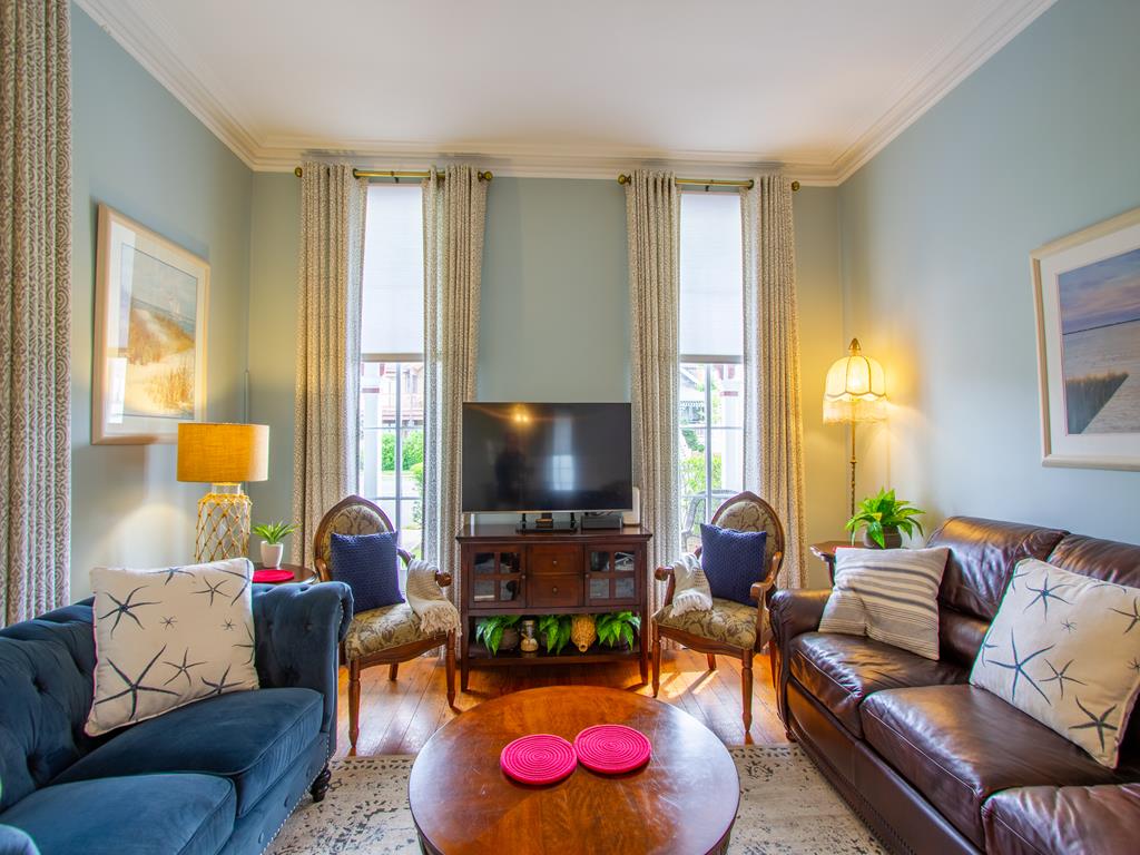 image The cozy living room offers a perfect blend of comfort and style with ample seating, elegant decor, and a view of the vibrant Historic District just outside.