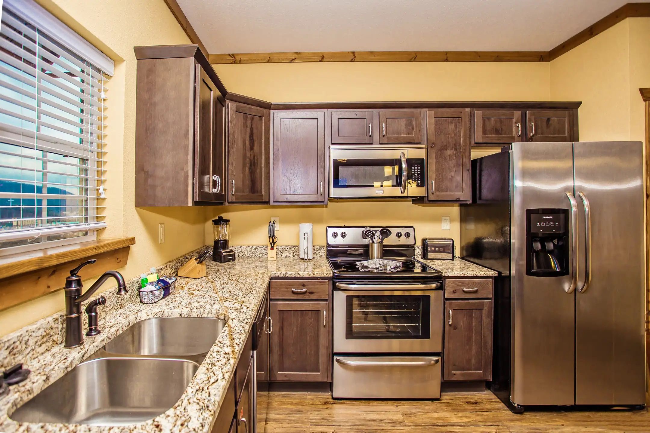 image This modern kitchen showcases sleek stainless steel appliances and elegant granite countertops, perfect for culinary enthusiasts seeking convenience and style.