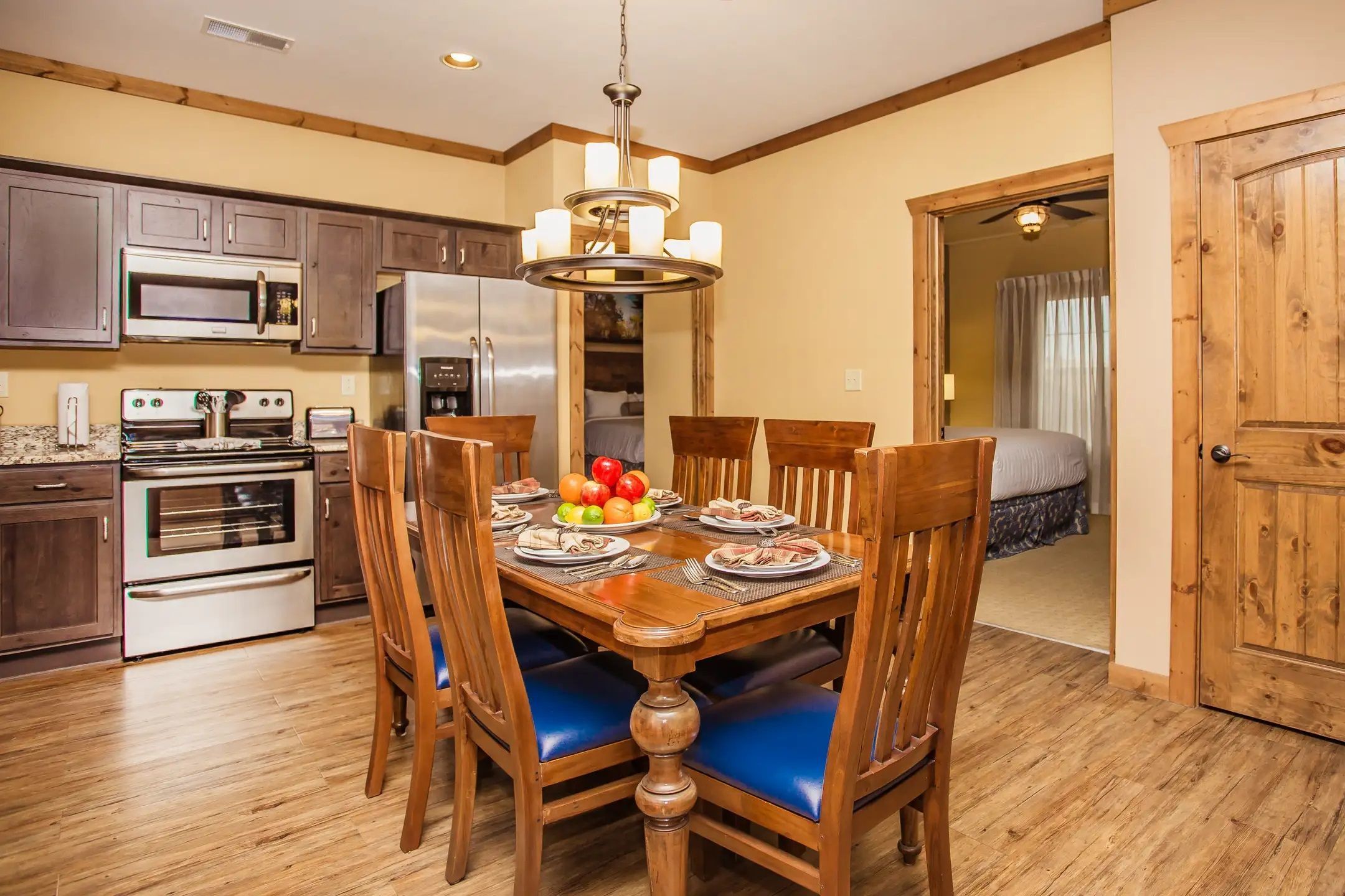 image Enjoy the inviting dining area with modern amenities, featuring a stylish table set under a chic chandelier, perfect for family gatherings in the heart of the Villas of Sedona.