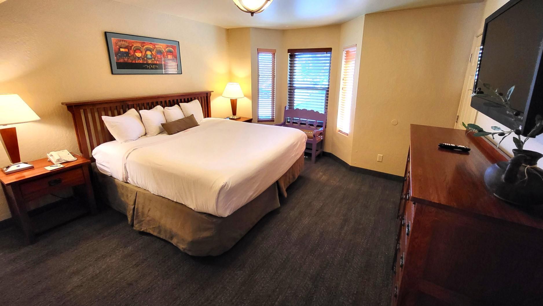 image The cozy bedroom invites you to unwind, offering ample natural light and comfortable furnishings for a peaceful retreat.