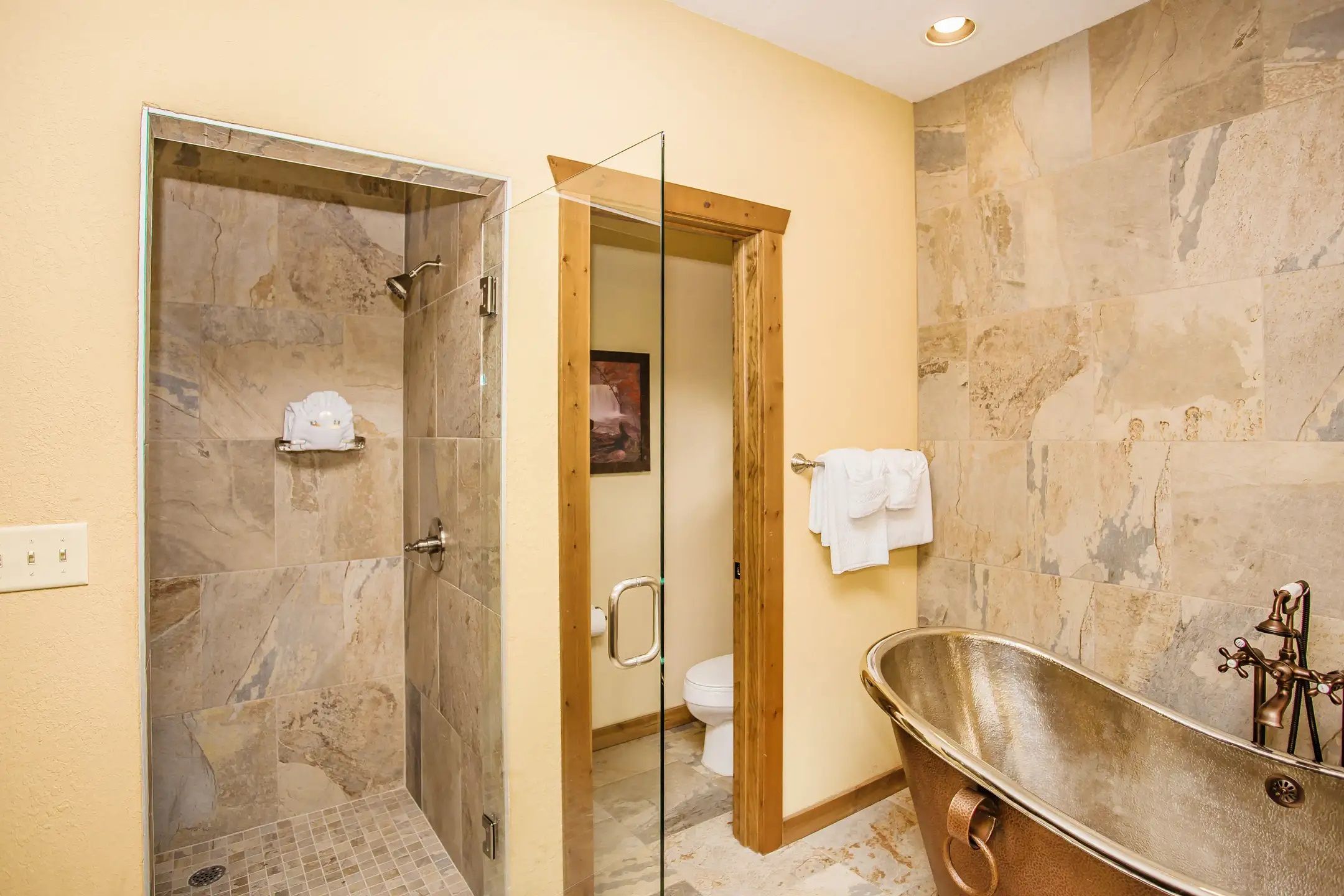 image Indulge in luxury with a beautifully designed bathroom featuring a stylish freestanding tub and a spacious glass shower.