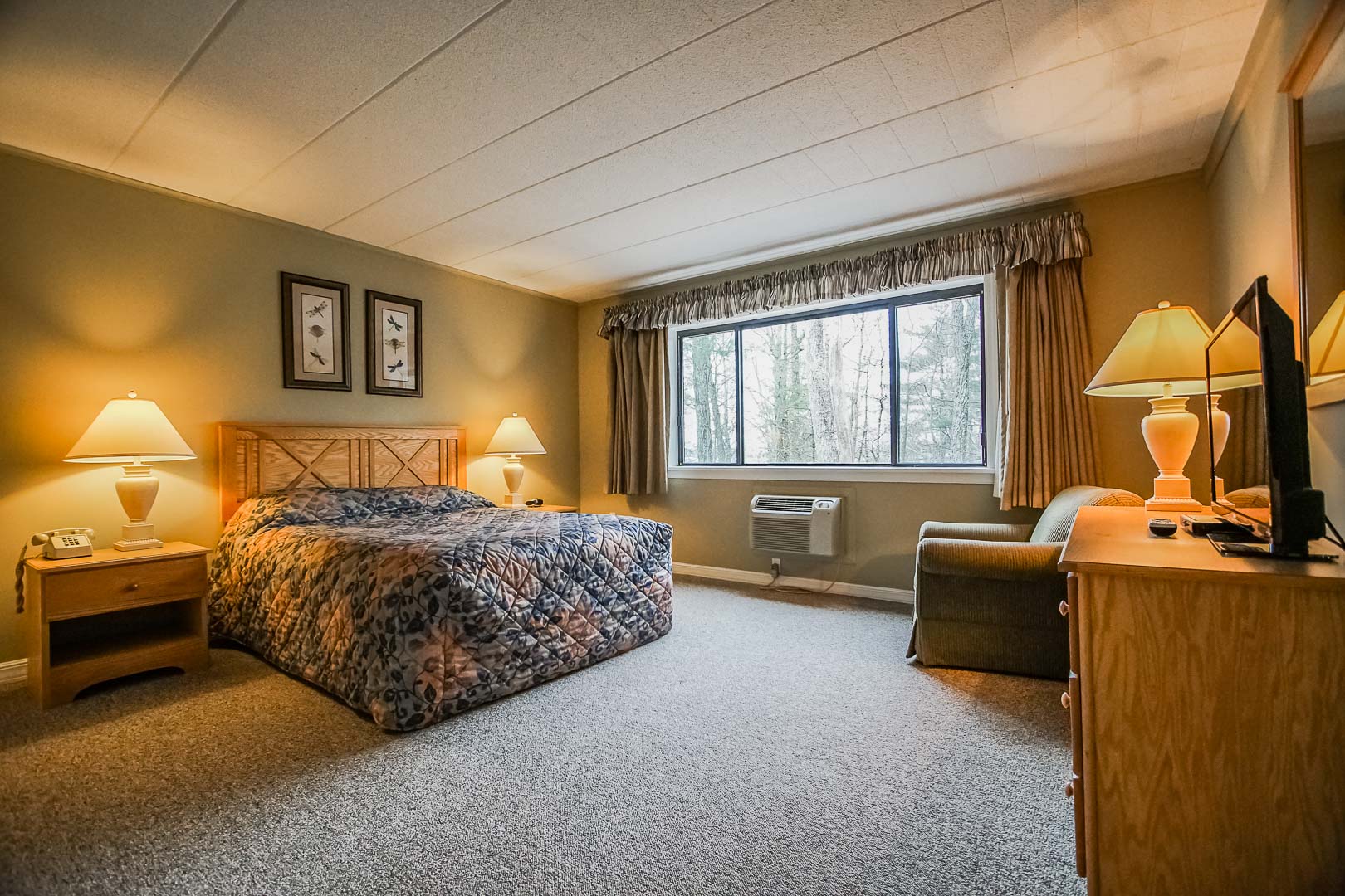 image This cozy bedroom features a queen bed and ample natural light, ideal for relaxation in your two-bedroom condo with modern amenities.