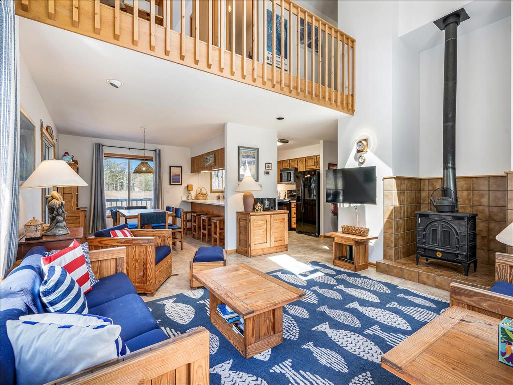image Expansive living room with vaulted ceilings and balcony views from above, creating an open, inviting space.
