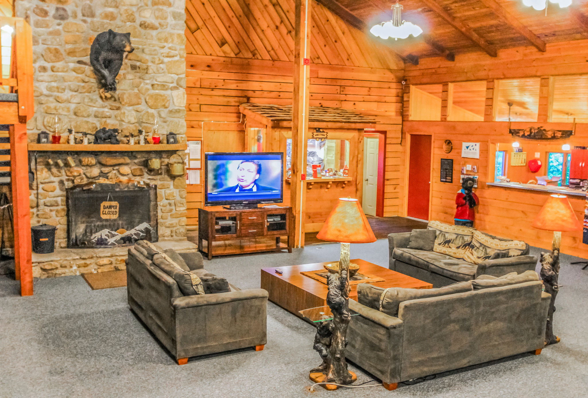 image The inviting common area boasts rustic wooden decor, a cozy fireplace, and a Smart TV, perfect for relaxing after a day of adventure.