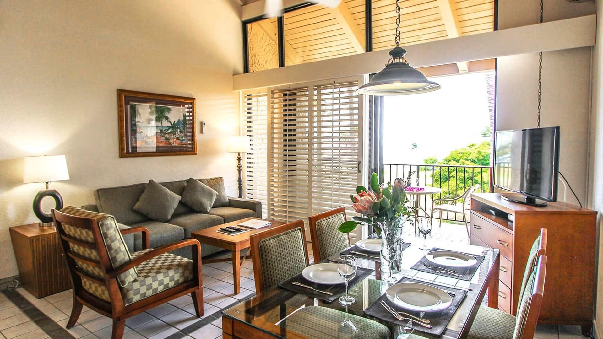 image This bright living space showcases modern decor with a dining area, a cozy sofa, and ample natural light streaming in from the patio doors.