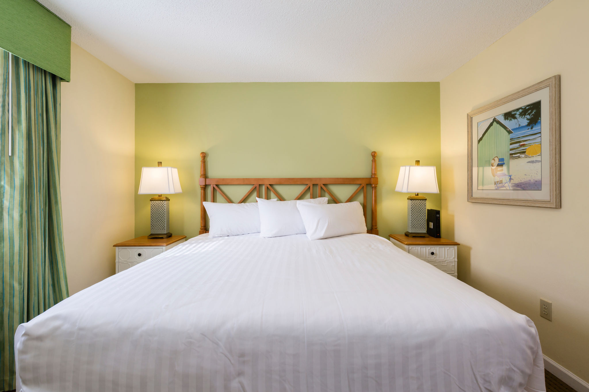 image Relax in the cozy bedroom with a queen bed, offering a serene ambiance and convenient amenities for a perfect getaway at Sandy Shores III.