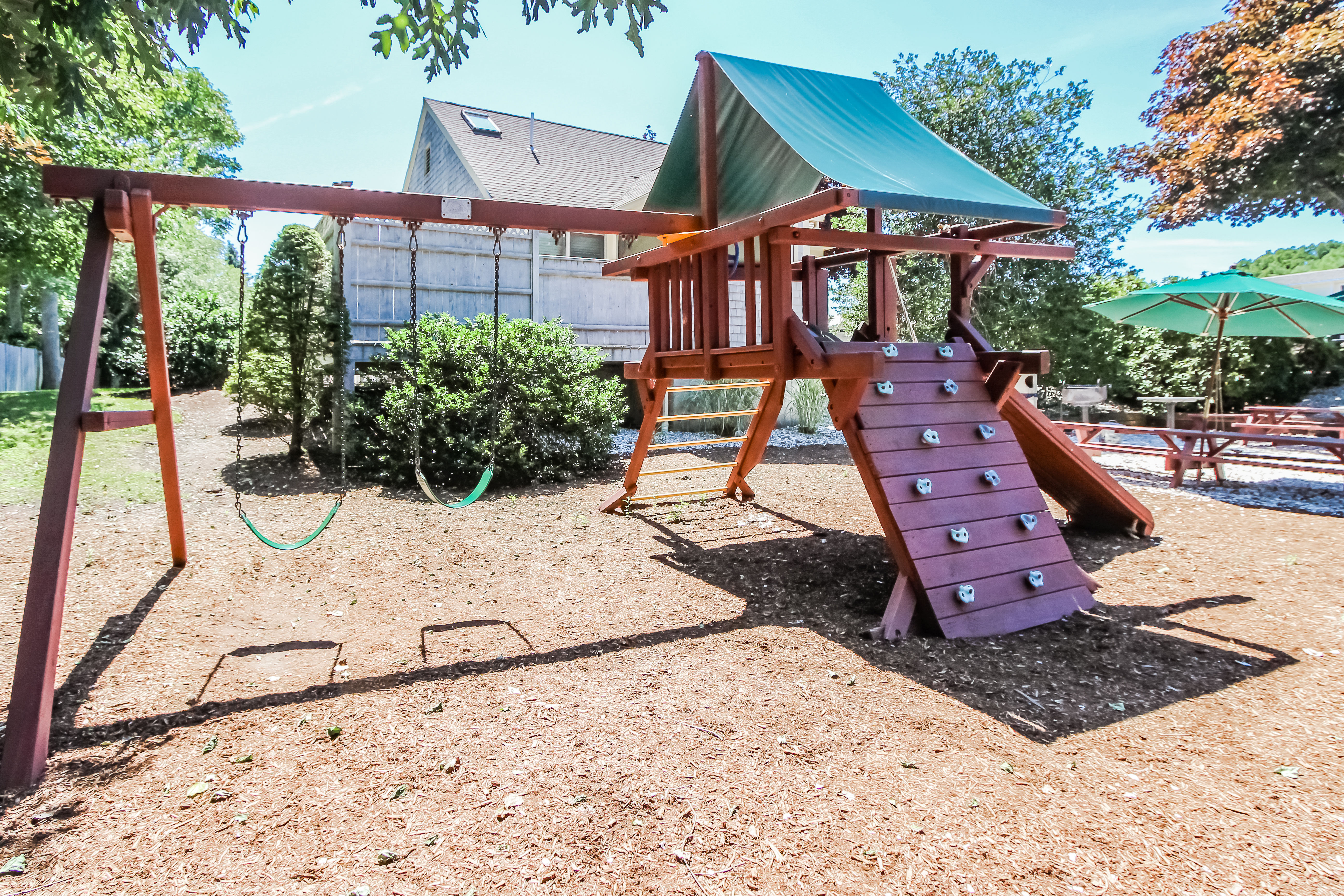 image The outdoor playground features swings and climbing structures, providing a safe and enjoyable space for children to play.