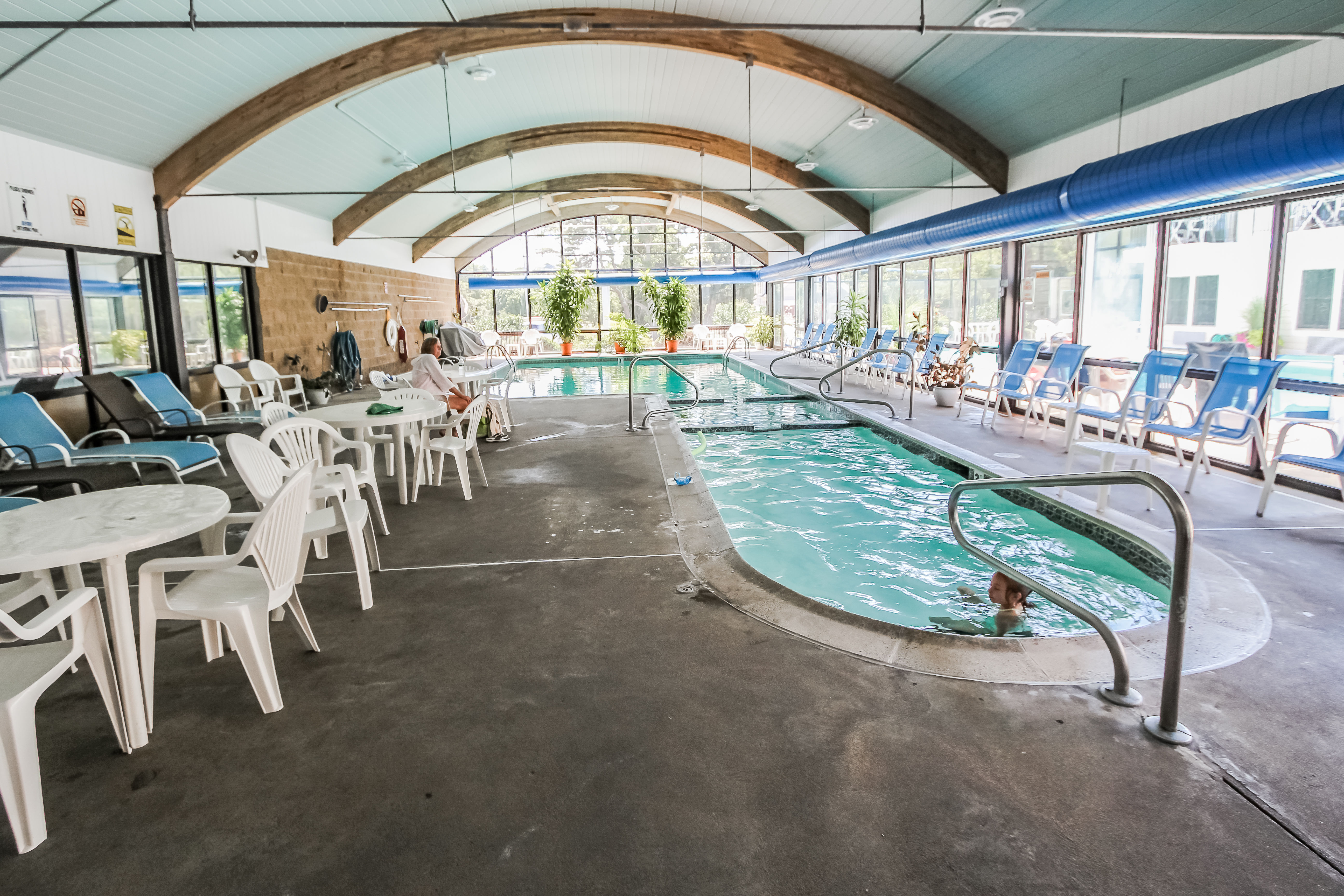image Dive into fun at the indoor pool, where families can enjoy leisure time in a spacious, well-lit environment with comfortable seating.