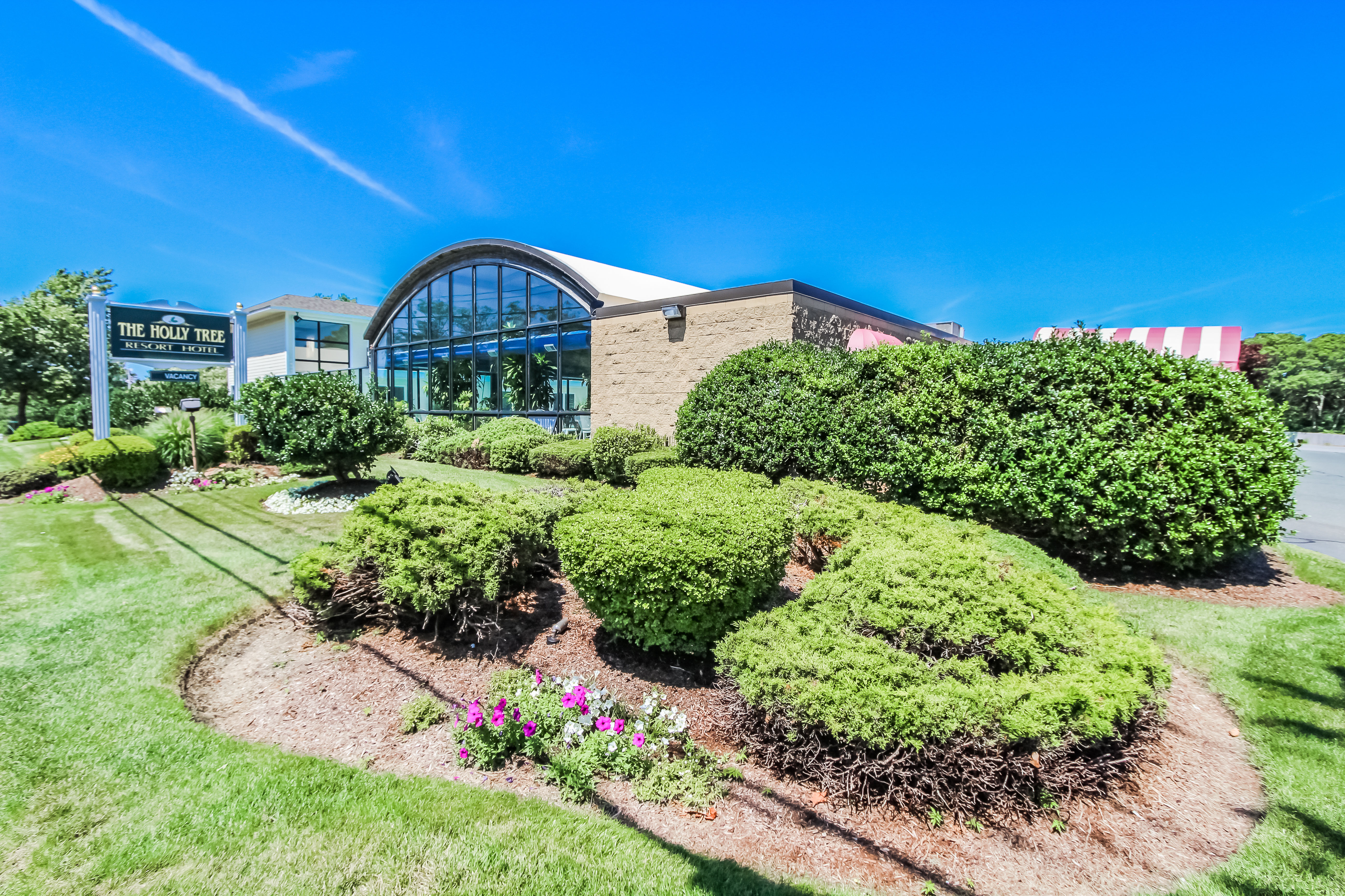 image The Holly Tree Resort welcomes you with its charming architecture and lush landscaping, providing a delightful start to your Cape Cod getaway.