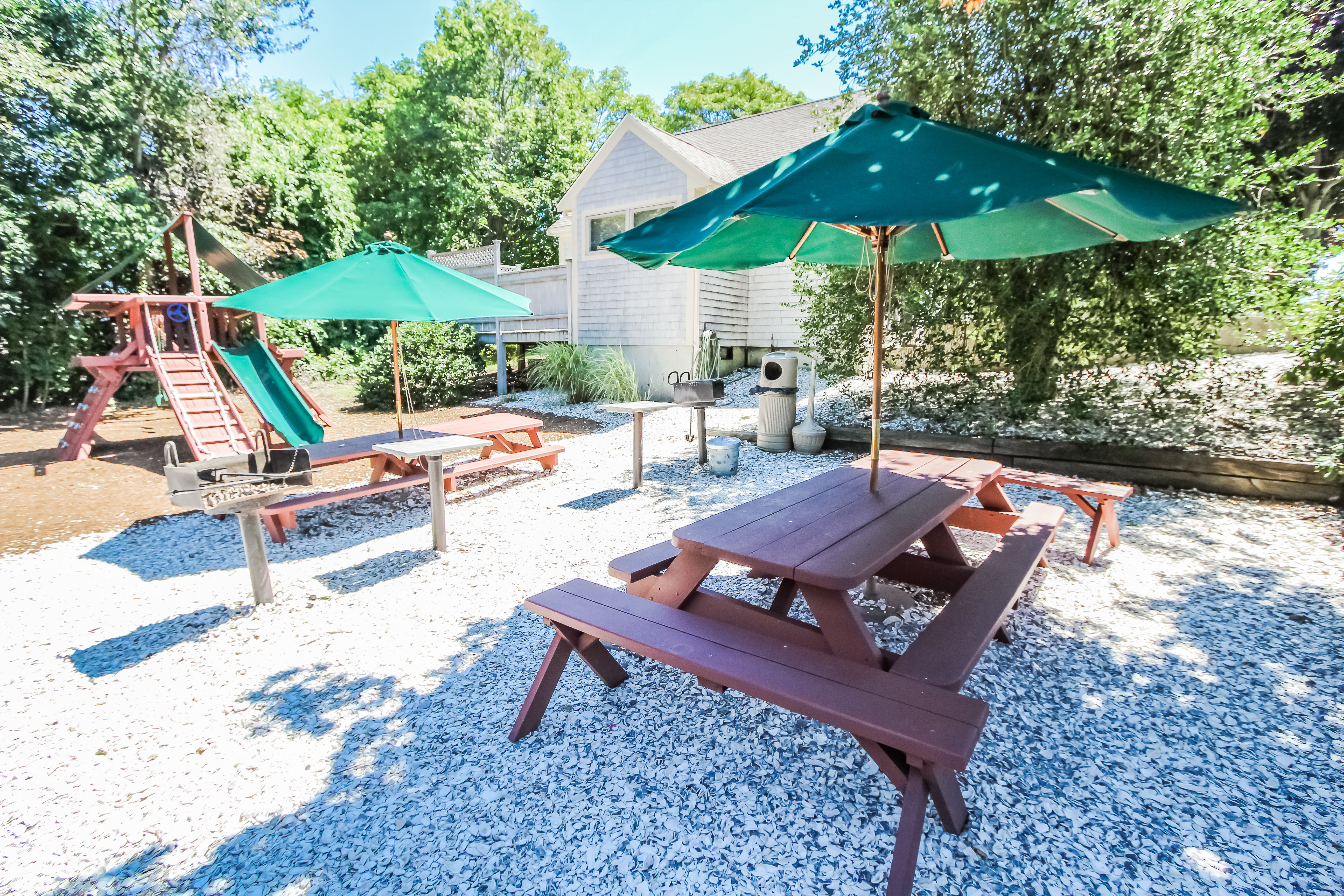 image The family-friendly BBQ area offers picnic tables and a playground, creating the perfect setting for outdoor meals and joyful playtime.