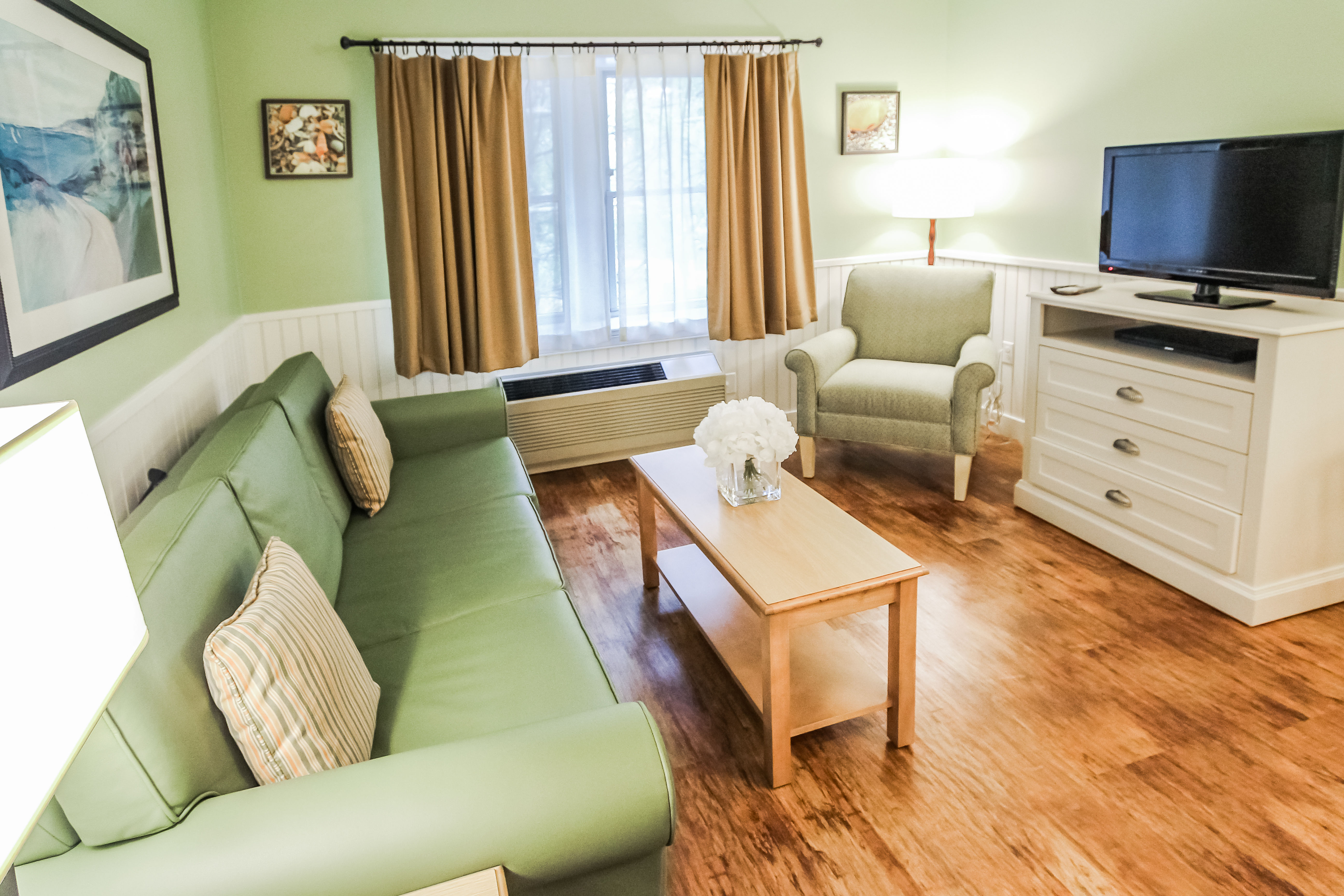 image Enjoy a cozy living area featuring a sleeper sofa and an entertainment system, ideal for unwinding after a day's adventure with loved ones.
