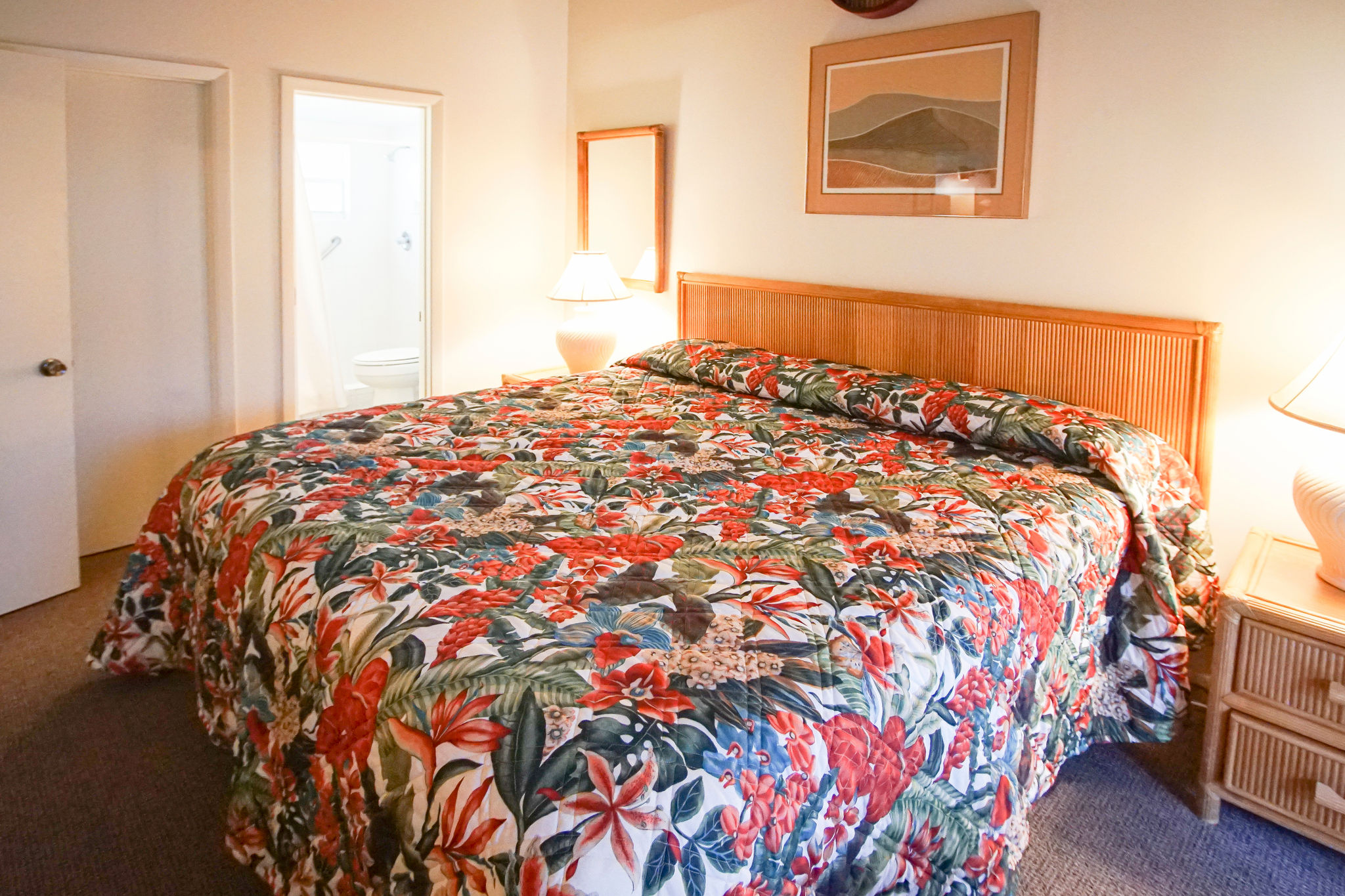 image This vibrant master bedroom features a cozy king bed adorned with tropical floral prints, providing a serene retreat just steps from the ocean.