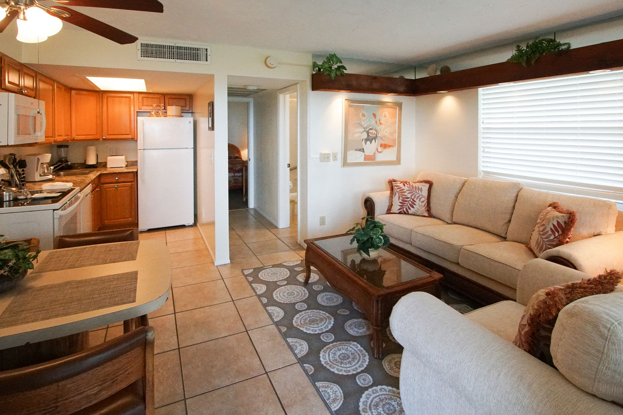 image The inviting living space features a modern full kitchen and comfortable furnishings, perfect for unwinding after a day at Palm Beach attractions.