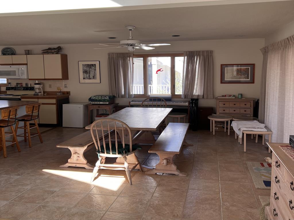 image The dining area features a large table and views from wide windows, perfect for family gatherings after beach days.