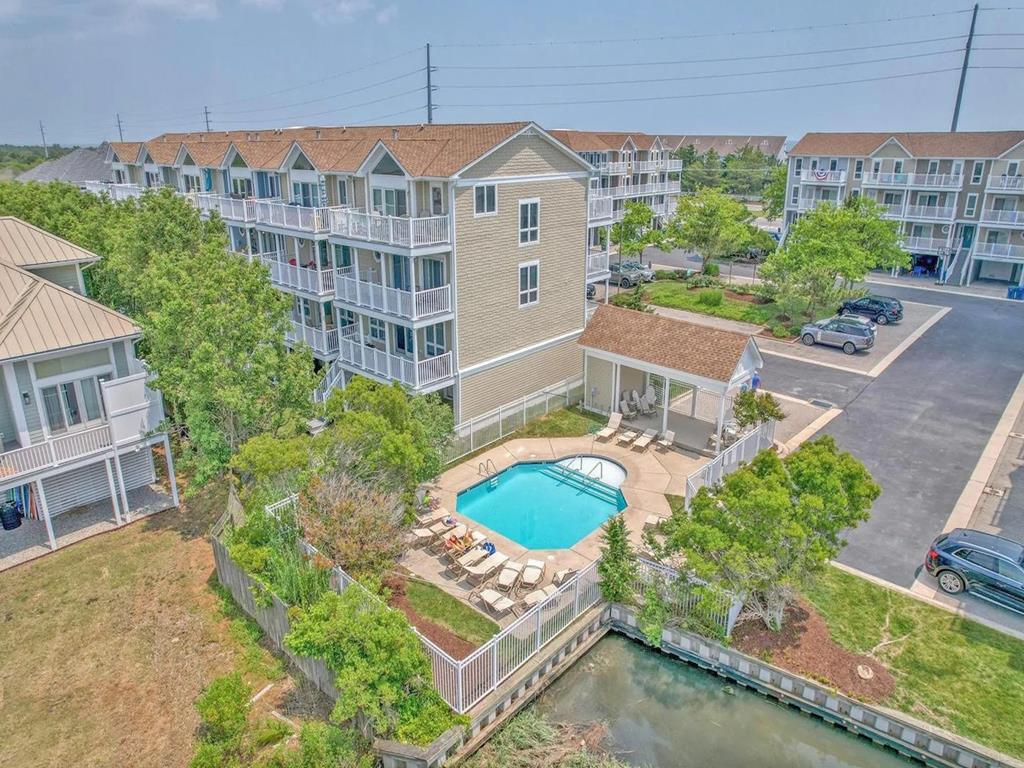 image Nestled among lush greenery, the inviting community pool offers a serene escape, complementing the relaxed atmosphere of this beautiful North Bethany environment.