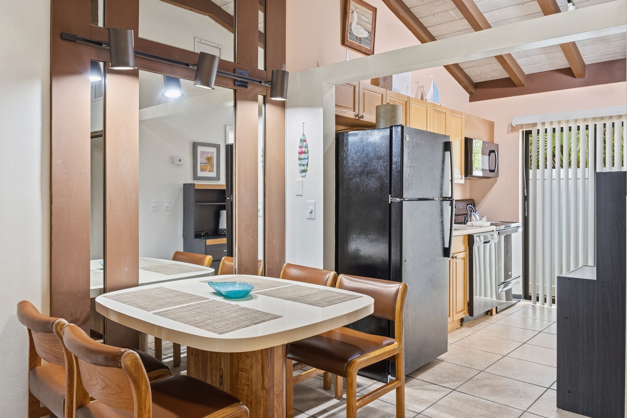 image The kitchenette includes a refrigerator, cabinetry, and nearby dining space for simple meals during your stay.