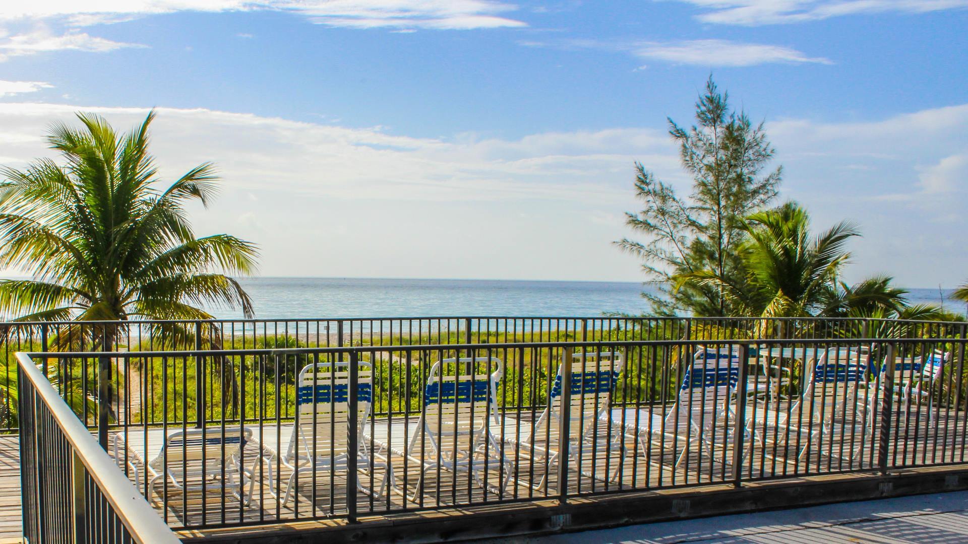image Unwind by the outdoor pool as you soak in breathtaking ocean views, enhancing your stay in this charming studio apartment.
