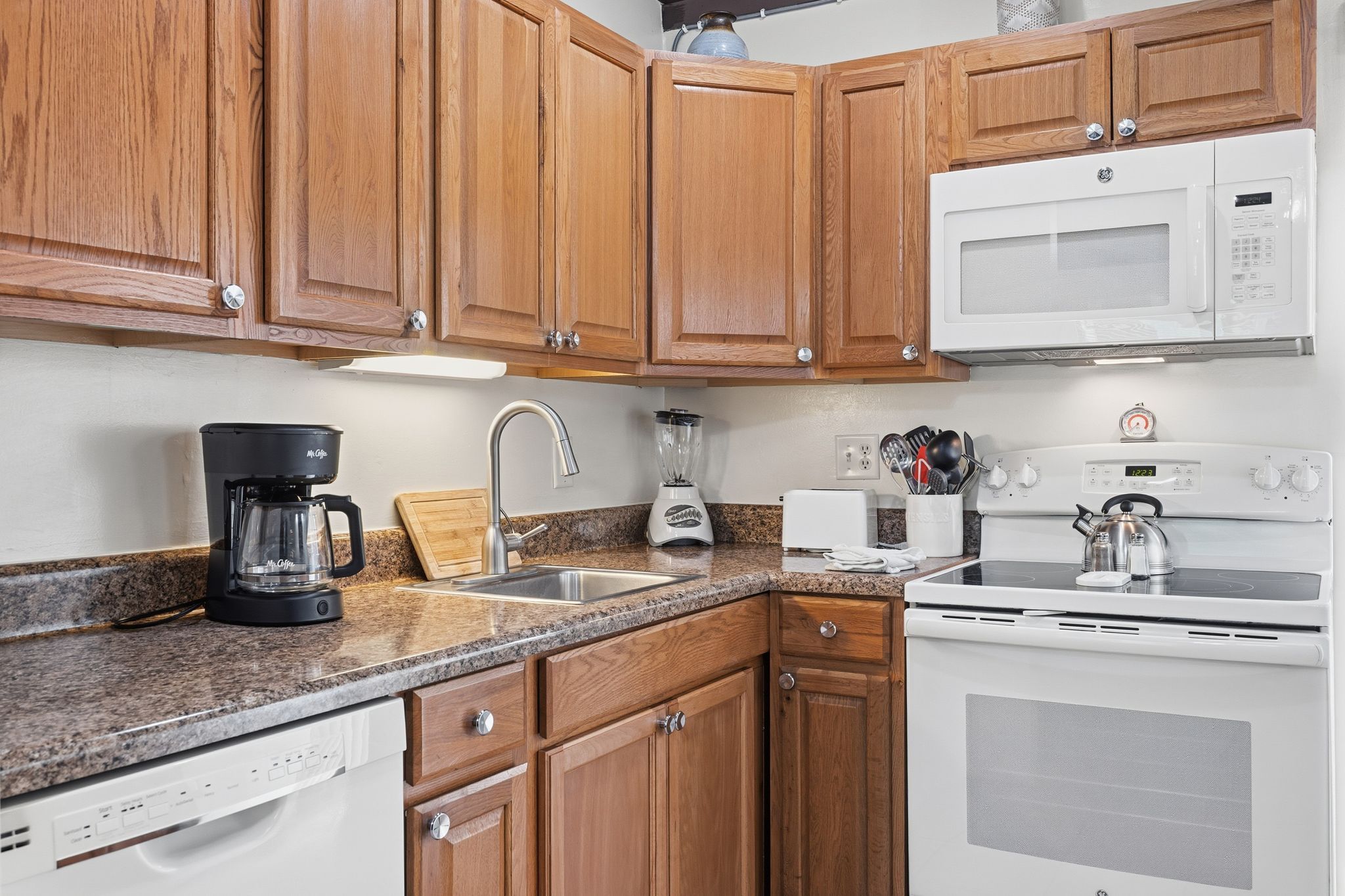 image A bright living space features a sofa, flat-screen TV, and coastal-inspired decor for relaxing after a day at the beach.