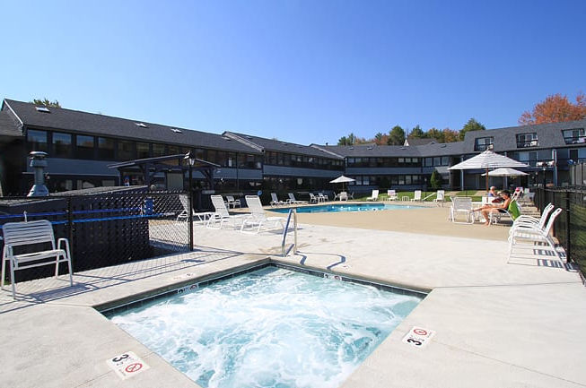 image Unwind in the inviting outdoor hot tub while soaking in serene views of the contemporary resort setting.