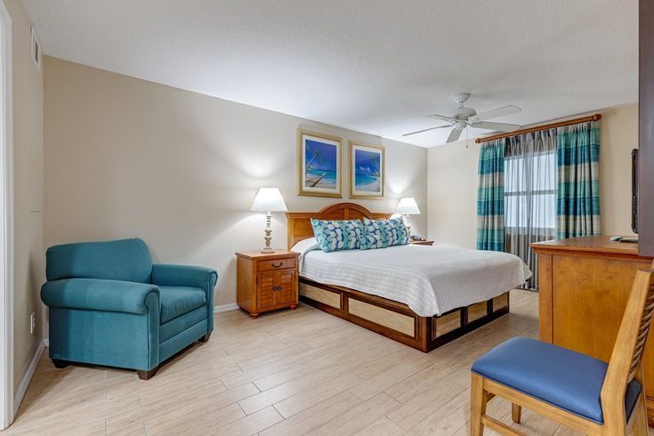 image This cozy bedroom features a comfortable queen bed, perfect for family relaxation after a beach day, complete with a scenic partial ocean-view balcony.