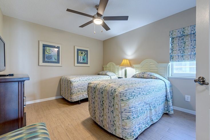 image Delight in the charm of this well-appointed room, ideal for families with two cozy beds and ample space.