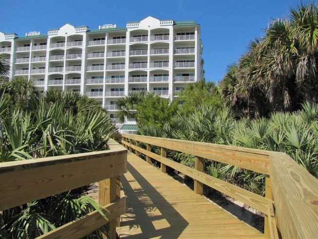 image An inviting boardwalk leads you straight from your accommodations to pristine beach access surrounded by tropical foliage.