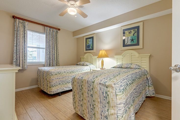 image Rest easy in the cozy twin guest room, featuring bright decor and comfortable beds, ensuring that your family feels right at home after a day of seaside adventures.