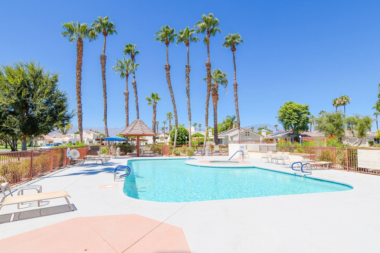 image Heated outdoor pool with palm trees and desert backdrops—ideal for sun-soaked relaxation.