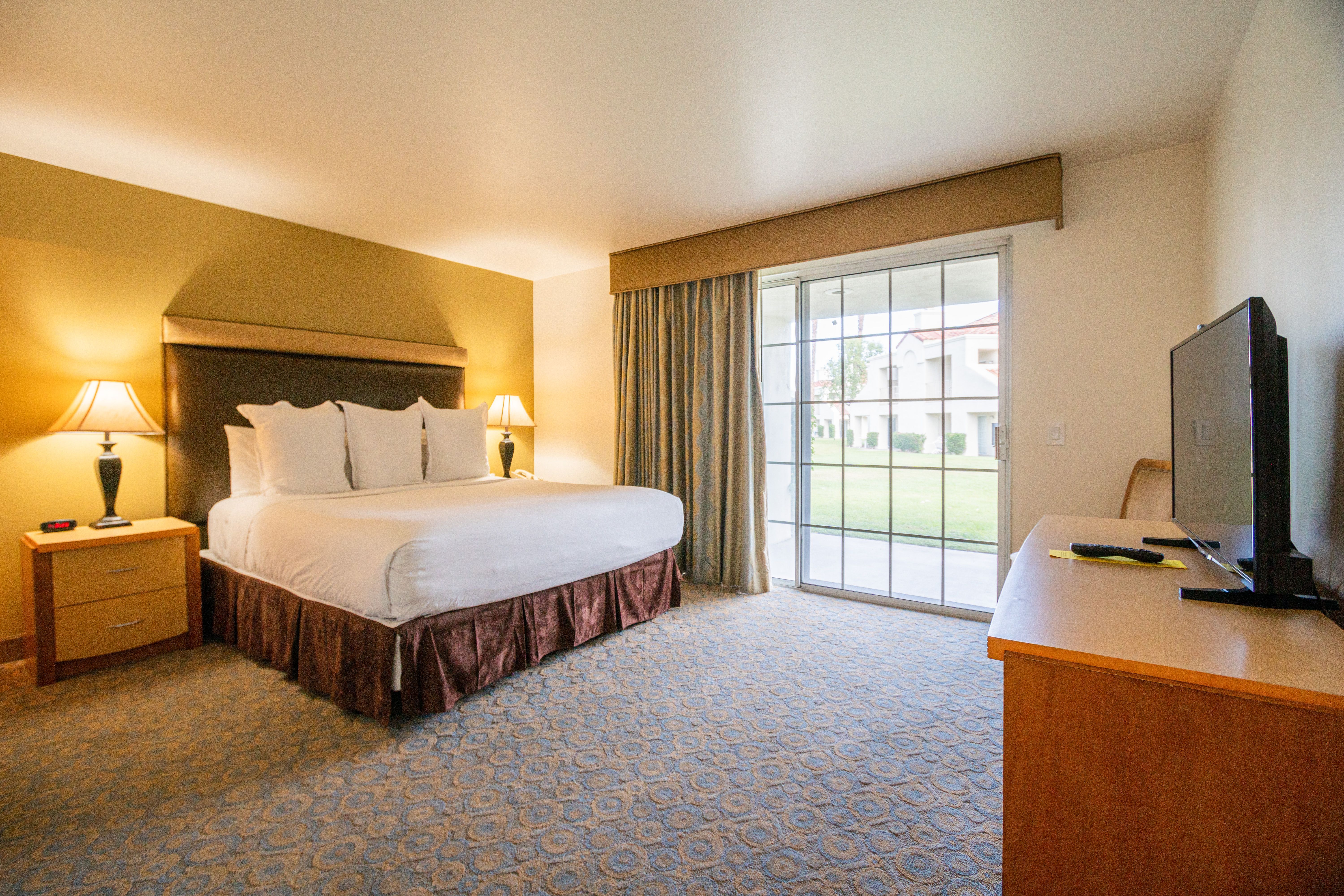 image Spacious bedroom with a king bed and access to the outdoors, perfect for restful desert nights.