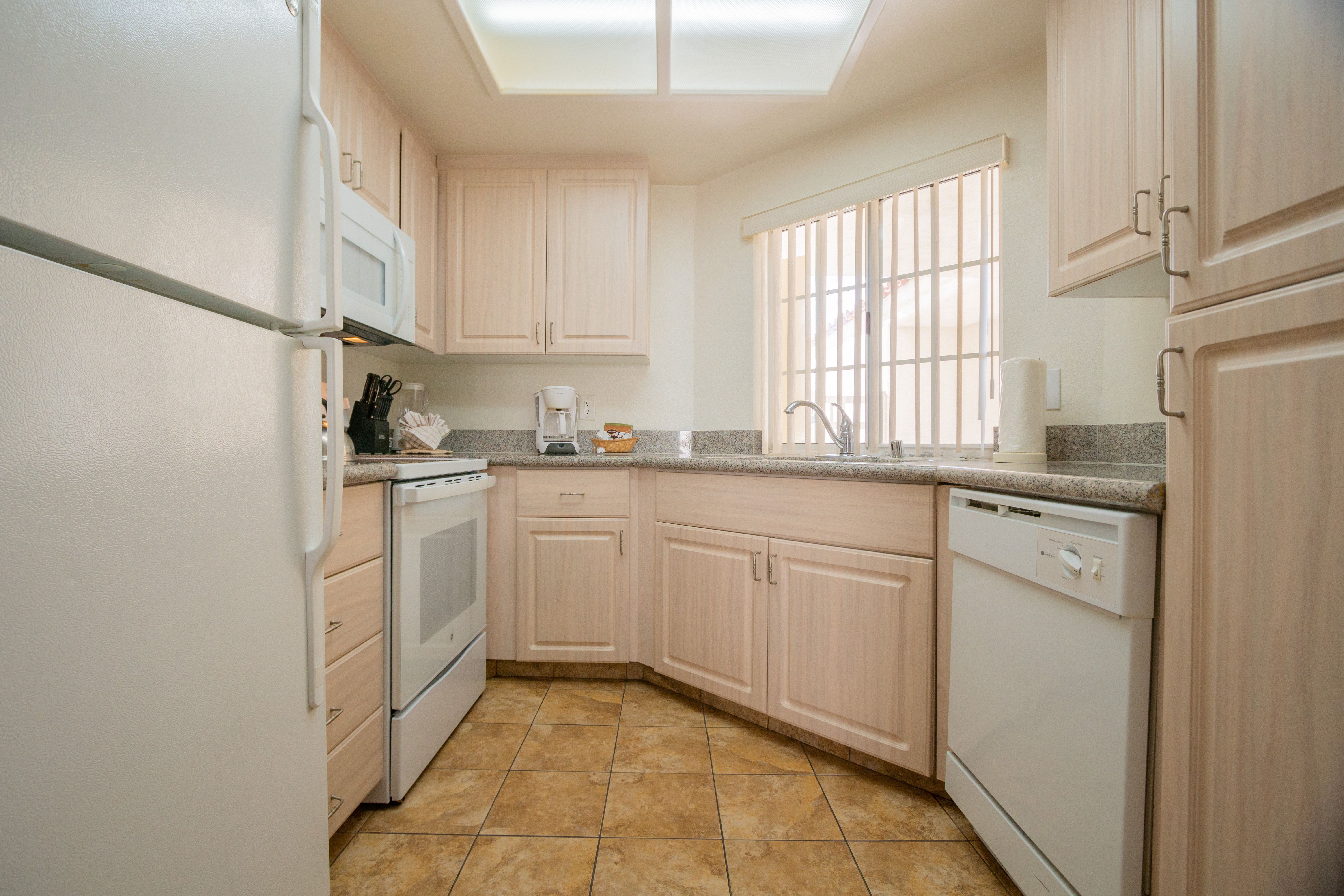 image The full kitchen, complete with modern appliances and ample counter space, invites culinary adventures and family meals in a cozy setting.