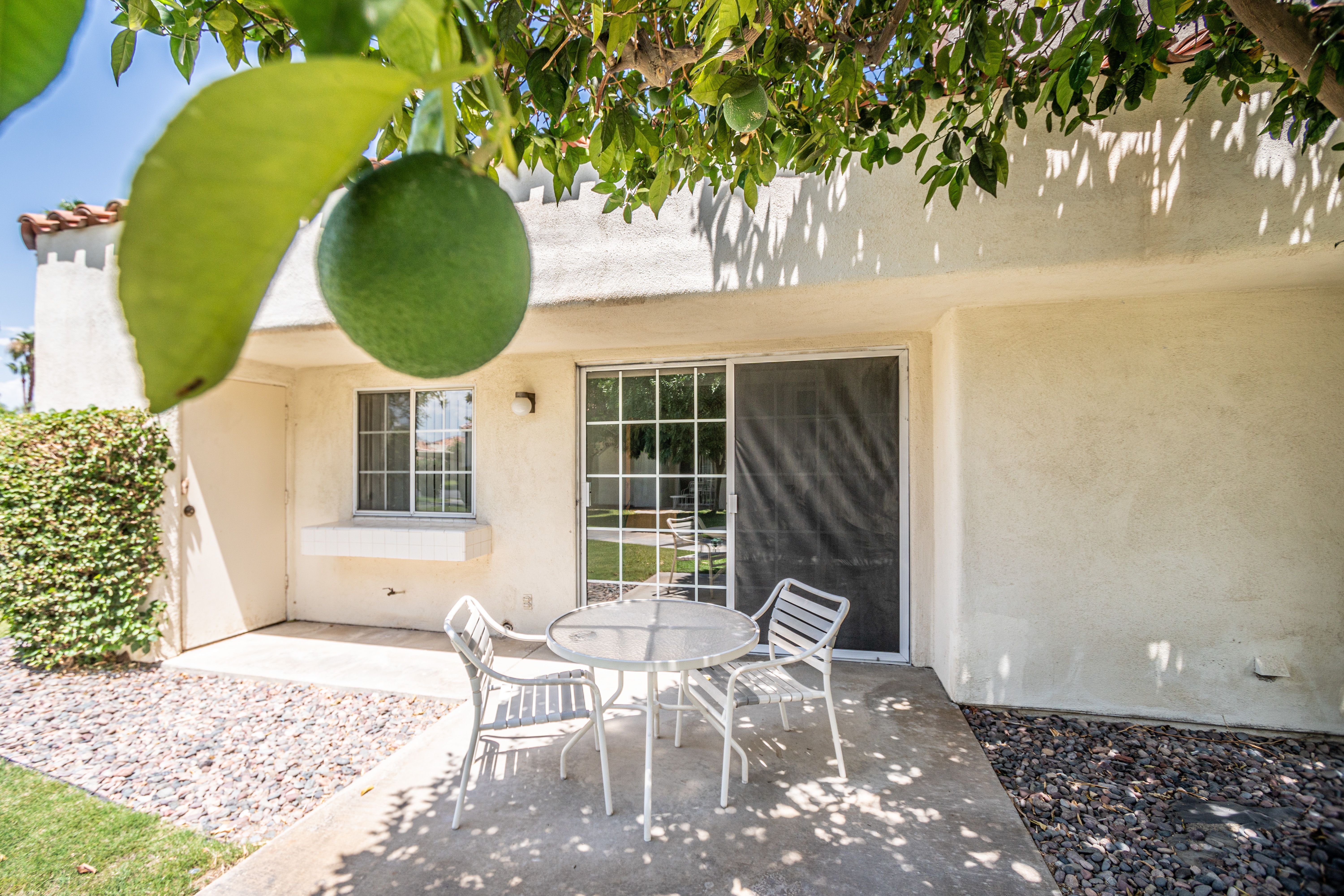 image Unwind on your private patio with seating, designed for relaxation amidst the beautiful surroundings, making it perfect for families and multi-generational travelers.
