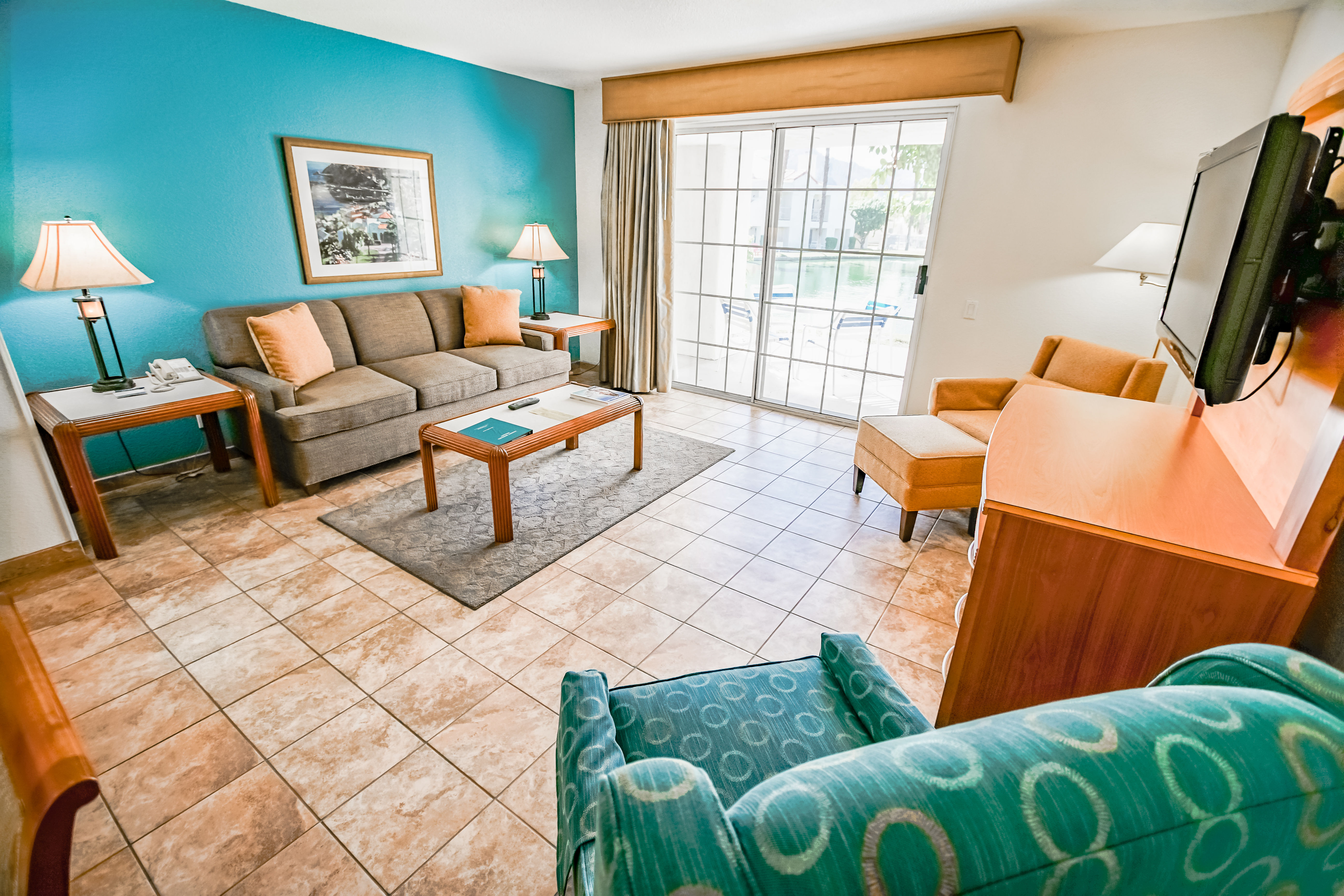 image The inviting living space features a cozy sofa, modern decor, and a private patio access, making it a comfortable retreat after a day of adventure.