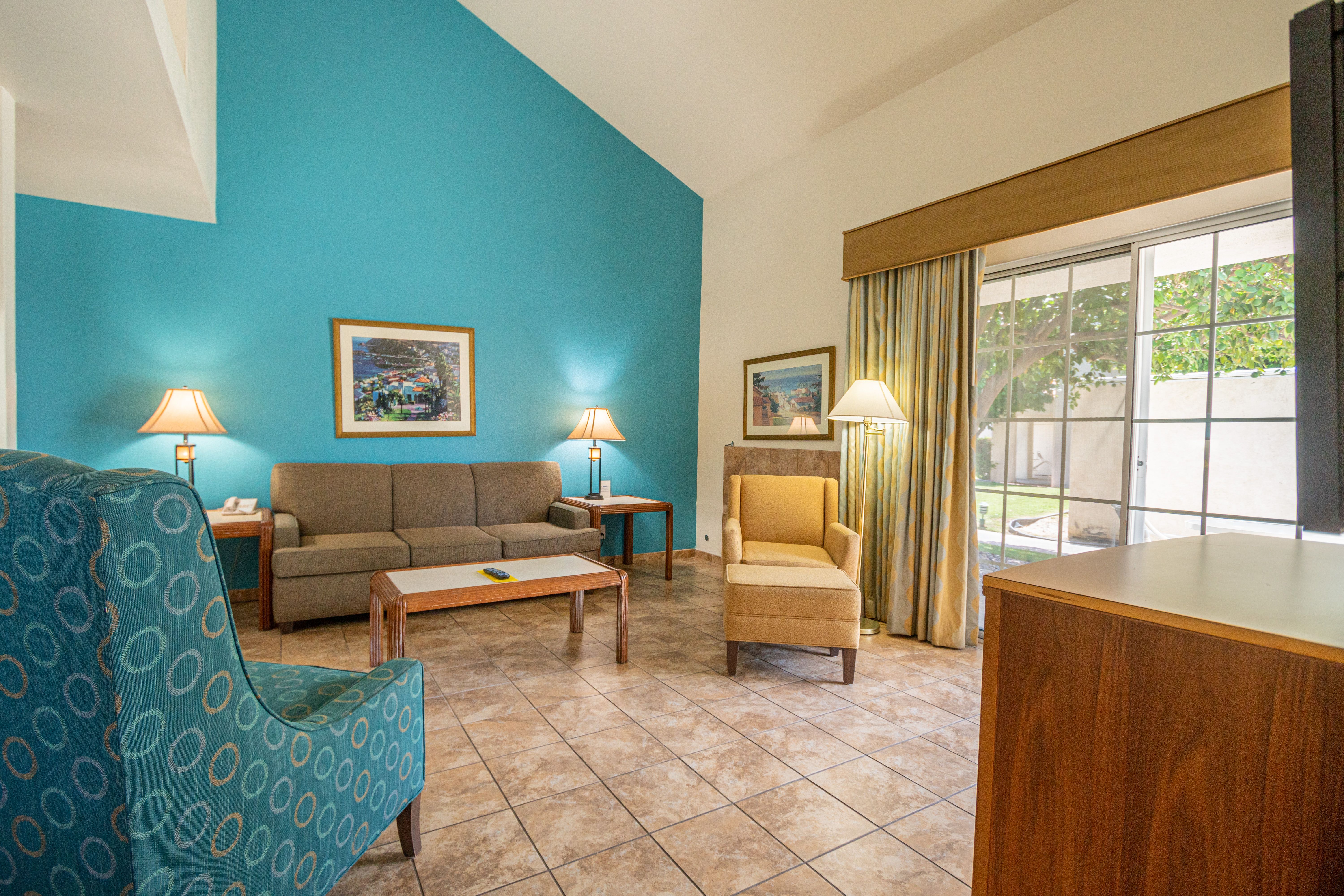 image The inviting living space features a cozy sofa, modern decor, and a private patio access, making it a comfortable retreat after a day of adventure.