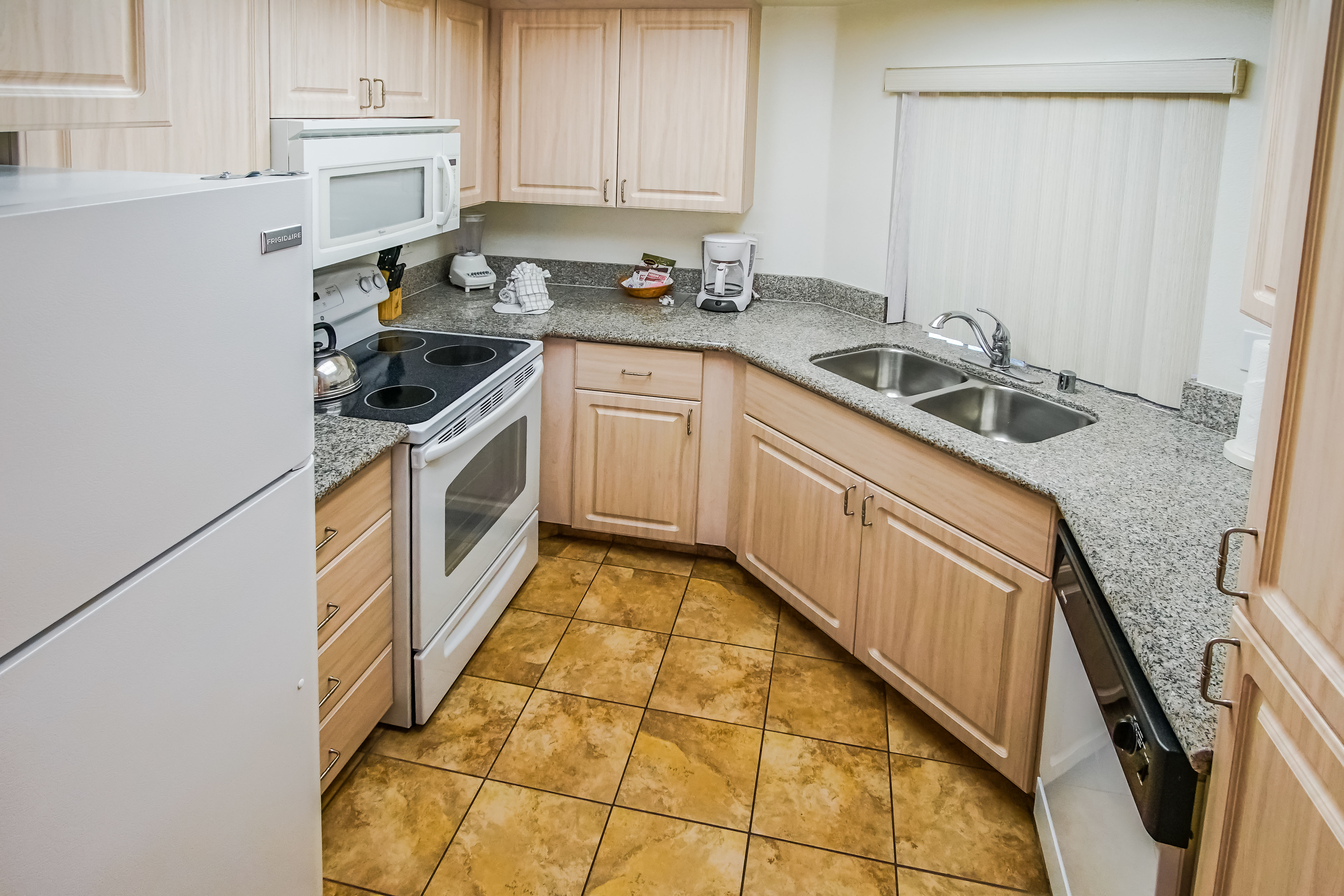 image Experience culinary convenience in this Palm Desert property’s full kitchen, featuring modern appliances and ample counter space for family meals.