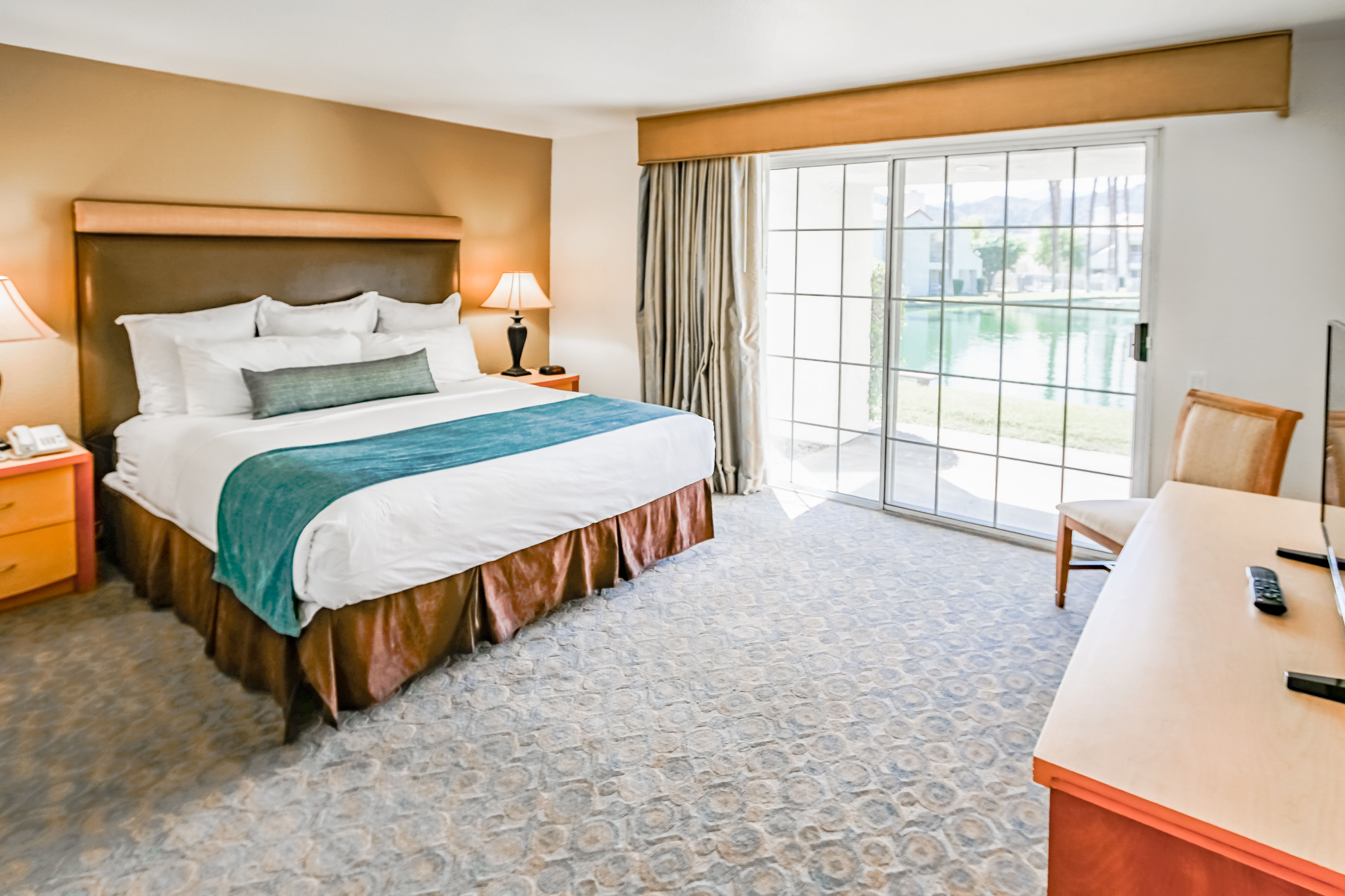 image A spacious bedroom provides a restful haven with ample natural light, plush bedding, and a serene view of the outdoor landscape, ensuring a peaceful night's sleep for all guests.