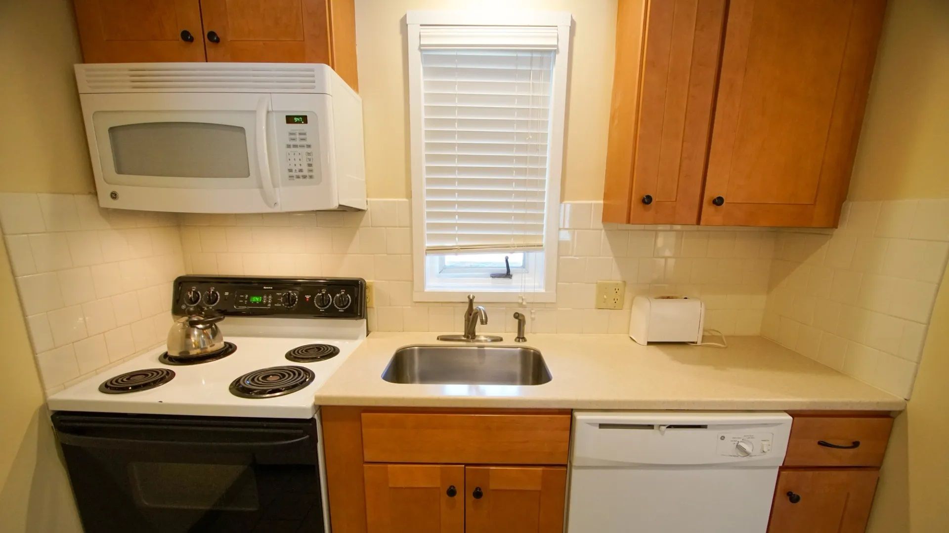 image This well-equipped kitchen, featuring modern appliances and ample counter space, offers the perfect environment for preparing meals during your stay.