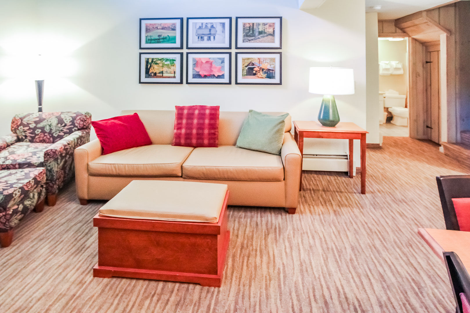 image Relax in the inviting living area of your loft cabin, featuring comfortable furnishings and easy access to private bedrooms and bathrooms for a home-away-from-home experience.