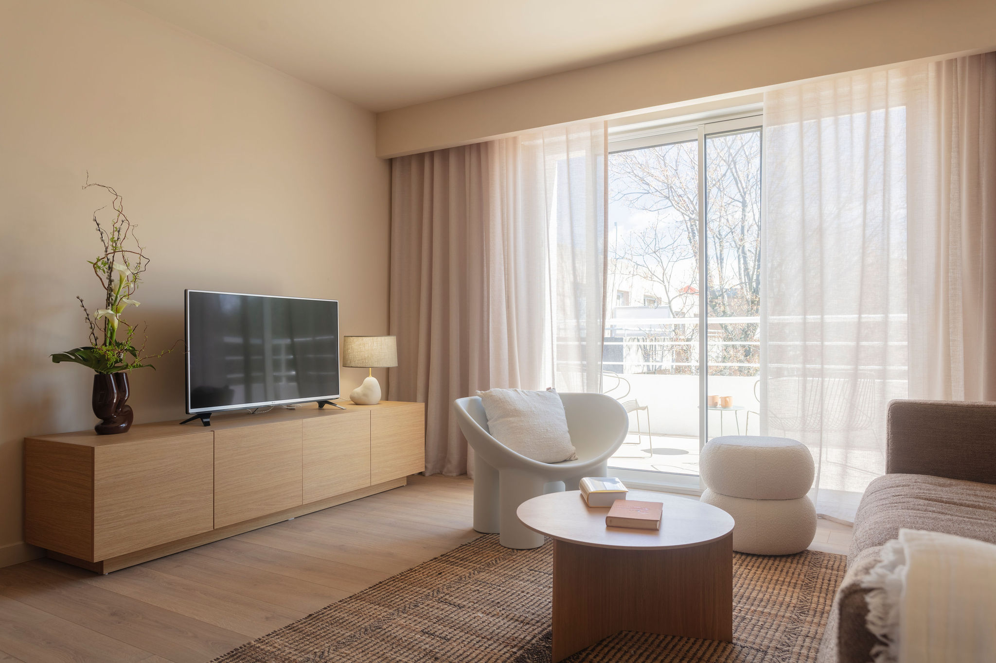 image Stylish living room with comfortable seating and a large TV, ideal for unwinding with family or friends.