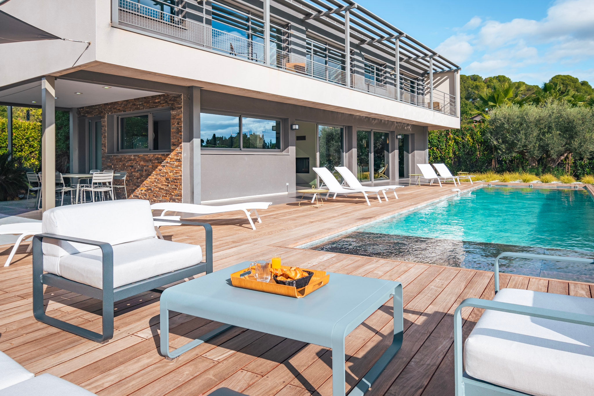 image Poolside deck with chic loungers—ideal for sunbathing and soaking in the tranquil garden surroundings.