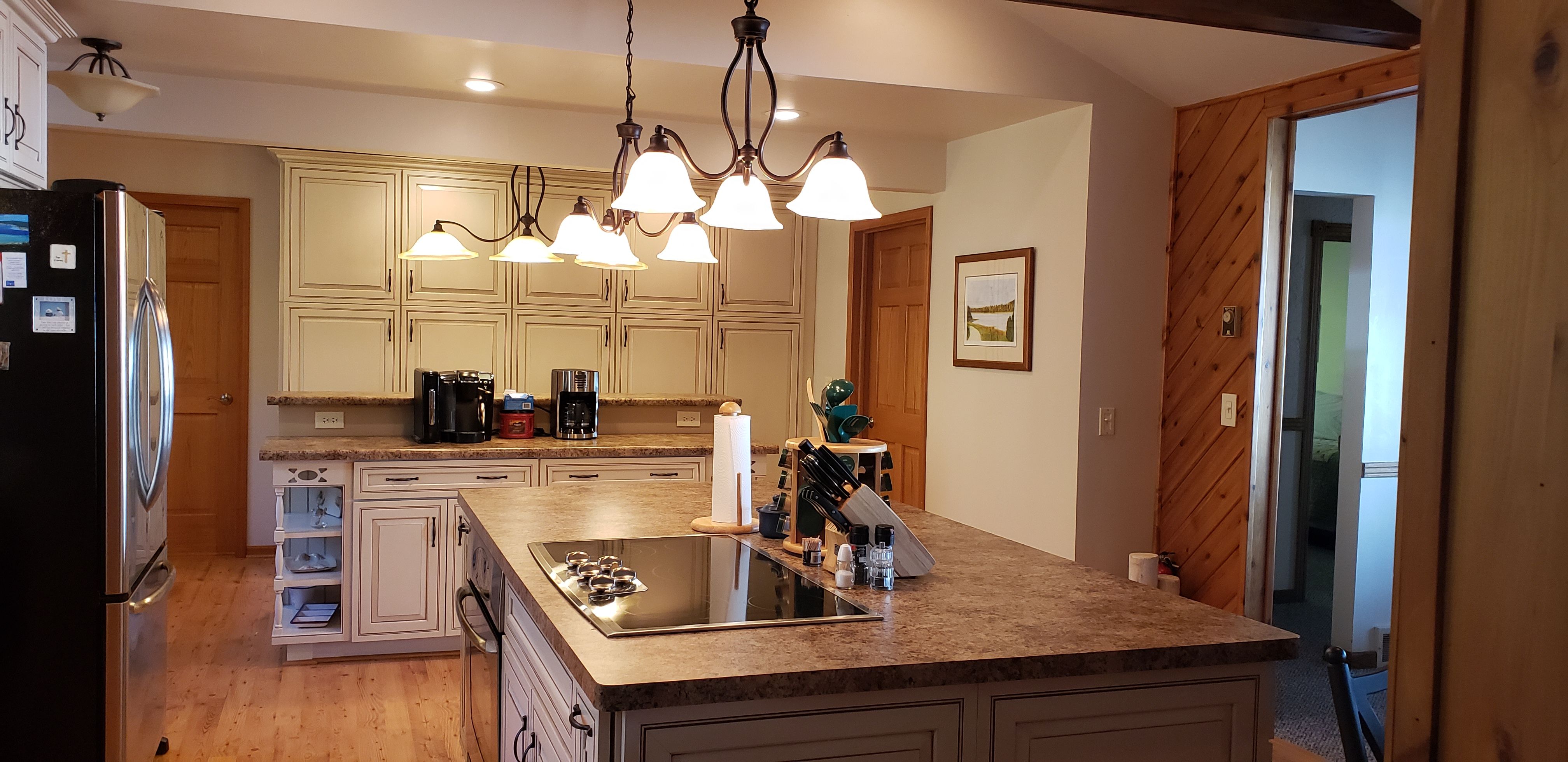 image Bright and functional kitchen with large island, perfect for prepping meals or gathering with loved ones.
