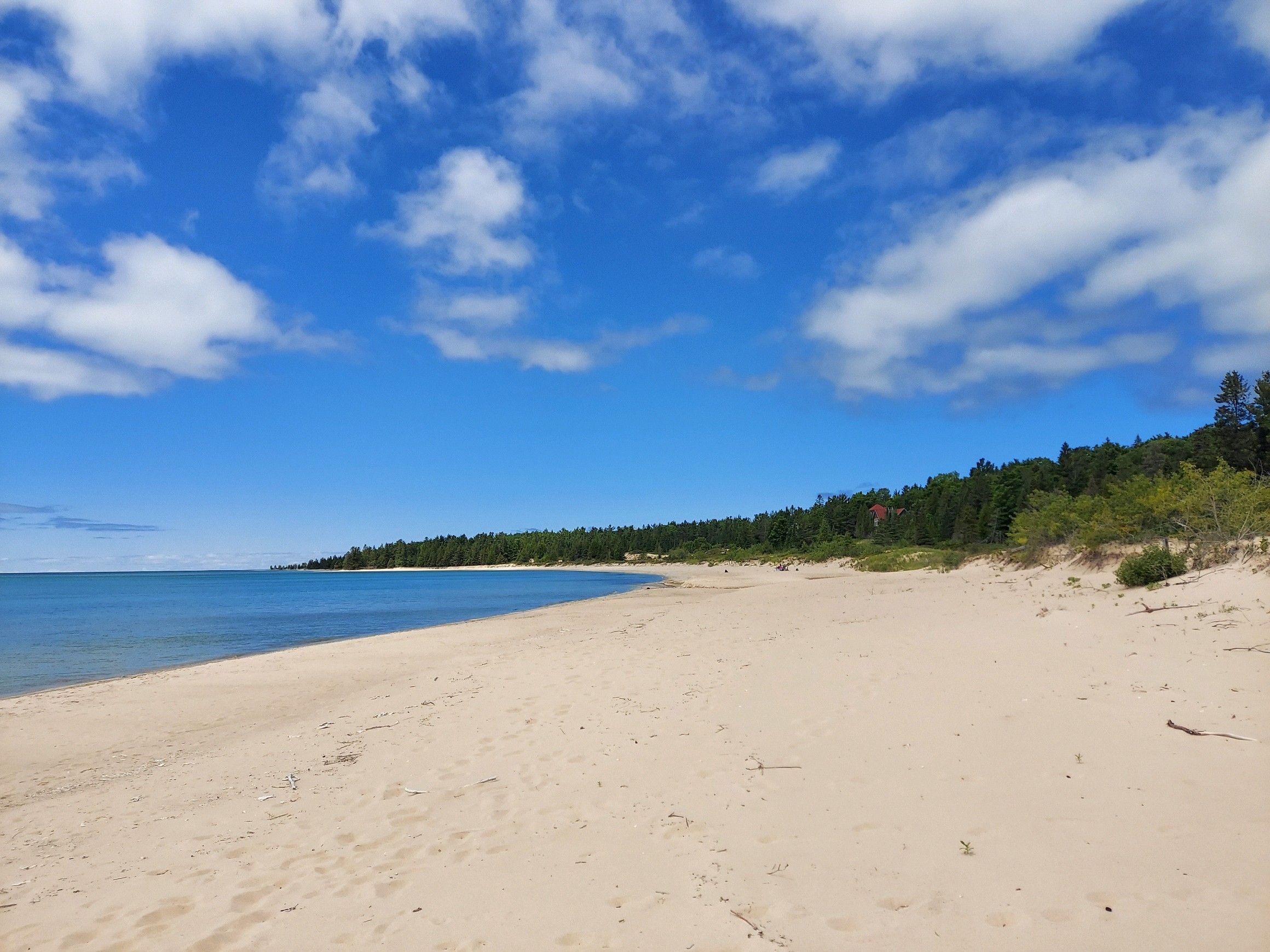 image Pristine sugar sand beach just steps away—perfect for a morning stroll or an afternoon swim in Lake Michigan.