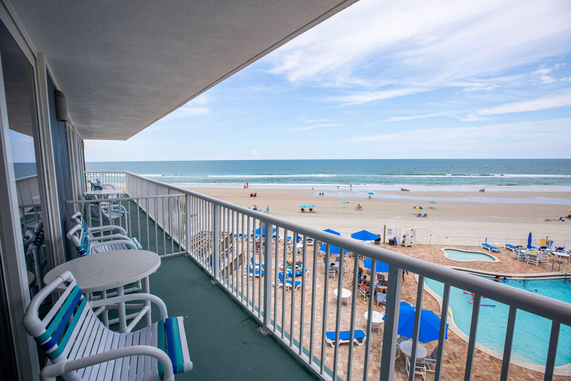 image Enjoy breathtaking beach views from your private balcony, where you can relax and listen to the gentle waves while overlooking the vibrant beach scene below.