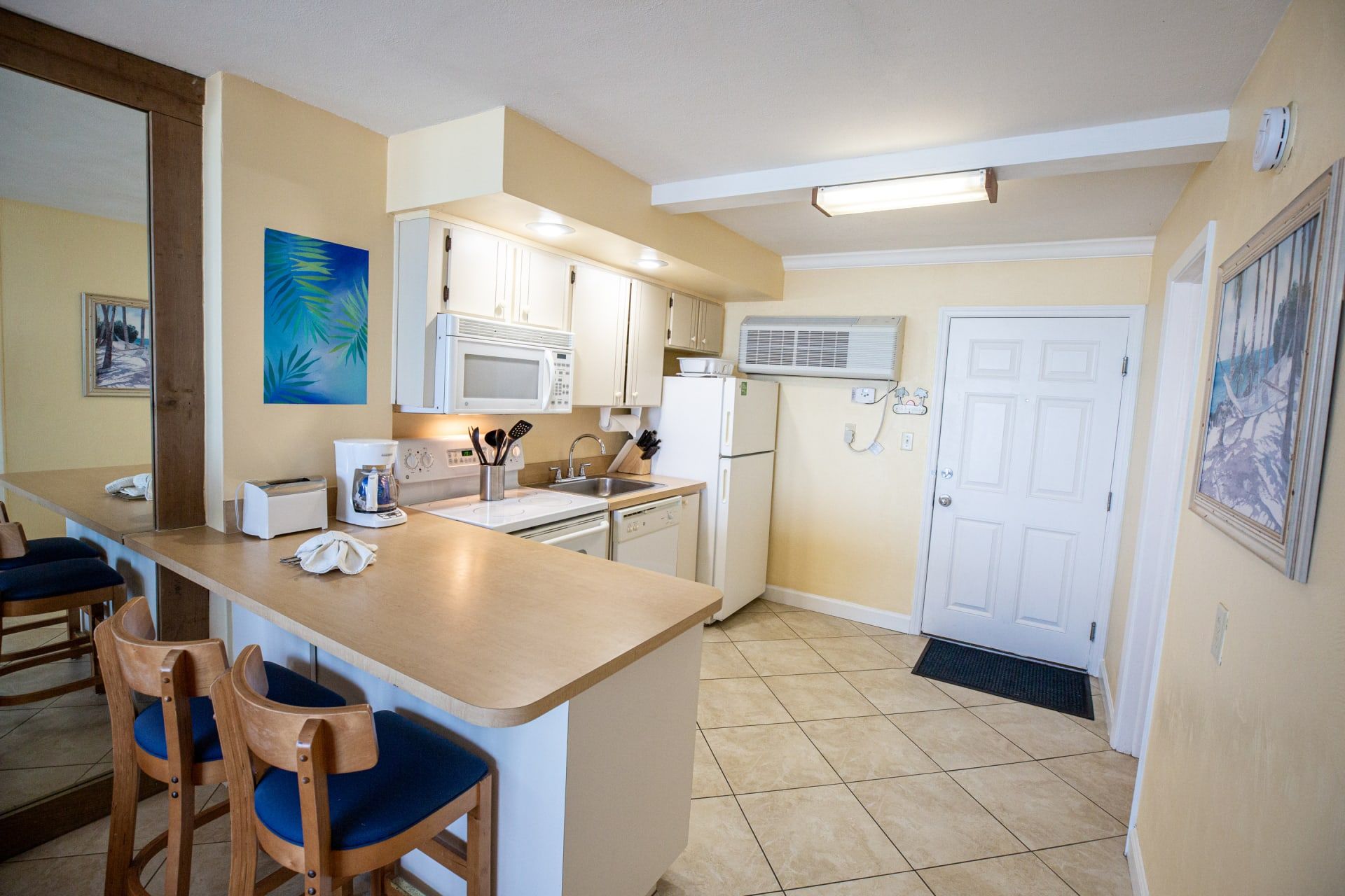image The fully equipped kitchen offers modern appliances and ample counter space, making meal preparation easy and enjoyable during your beachfront stay.