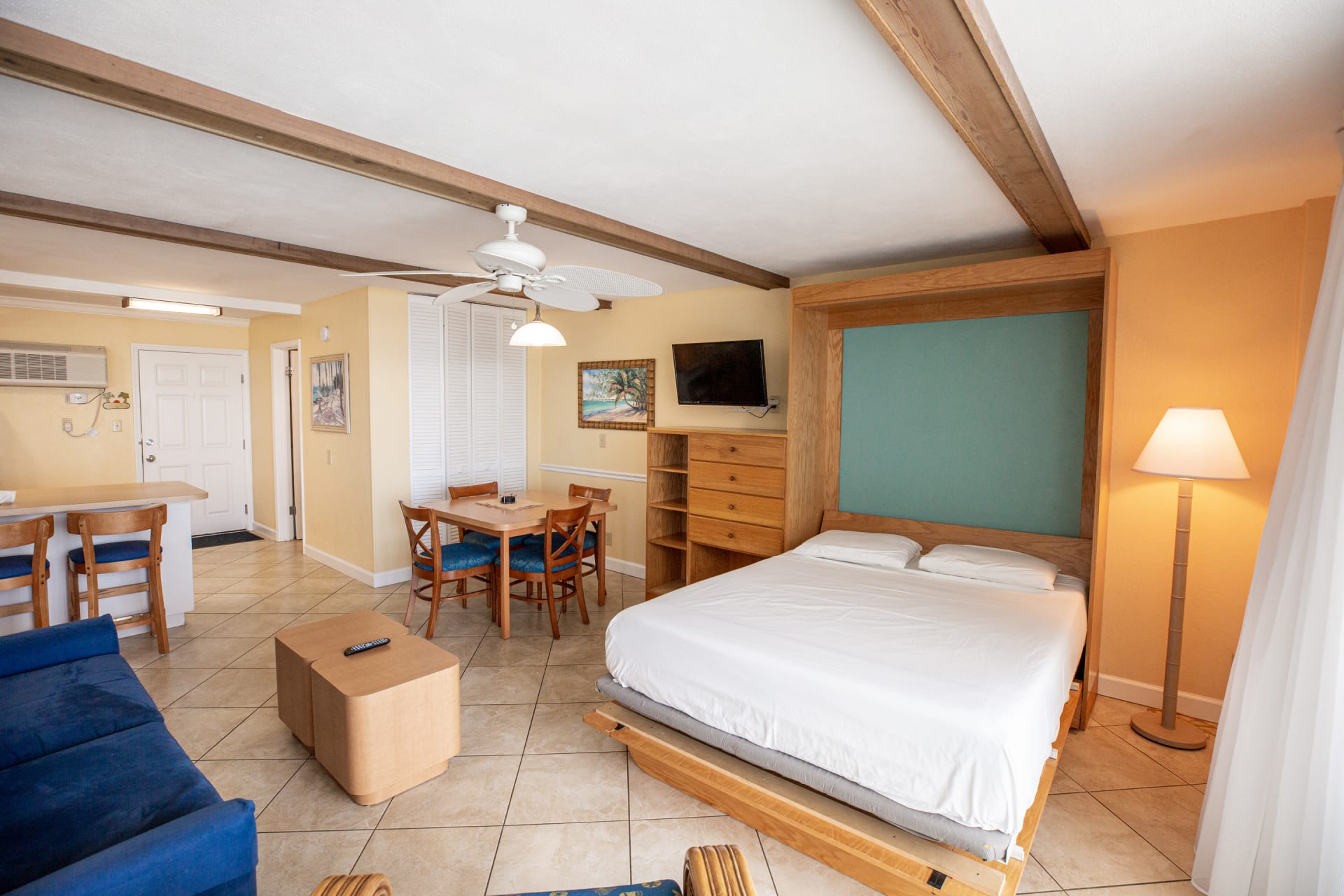 image The studio's versatile design showcases the Murphy bed in a convenient setup, seamlessly blending a functional living area with stylish décor, perfect for a beach getaway.