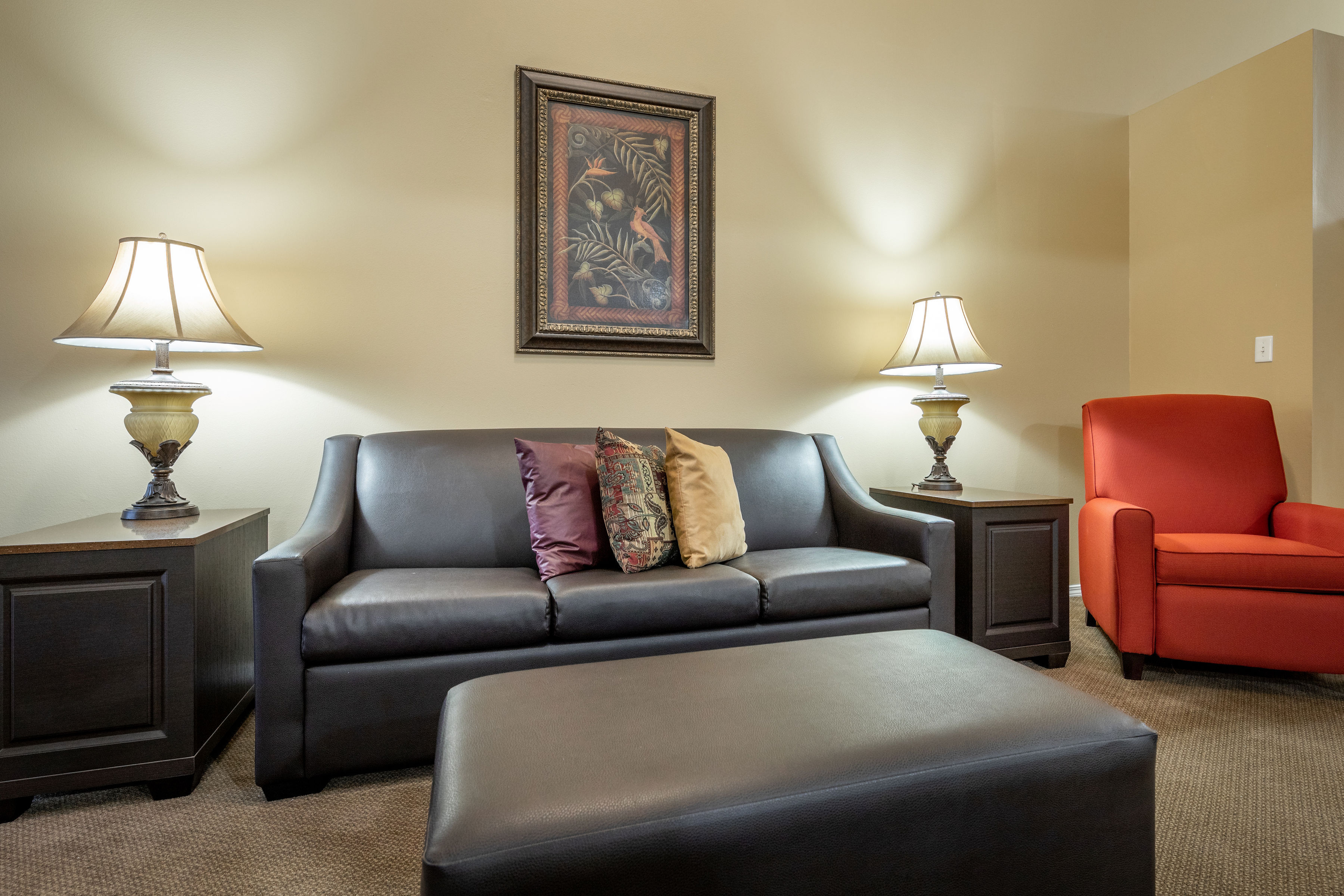 image The living room boasts a modern, stylish couch adorned with decorative pillows, offering a sleek and cozy gathering space.