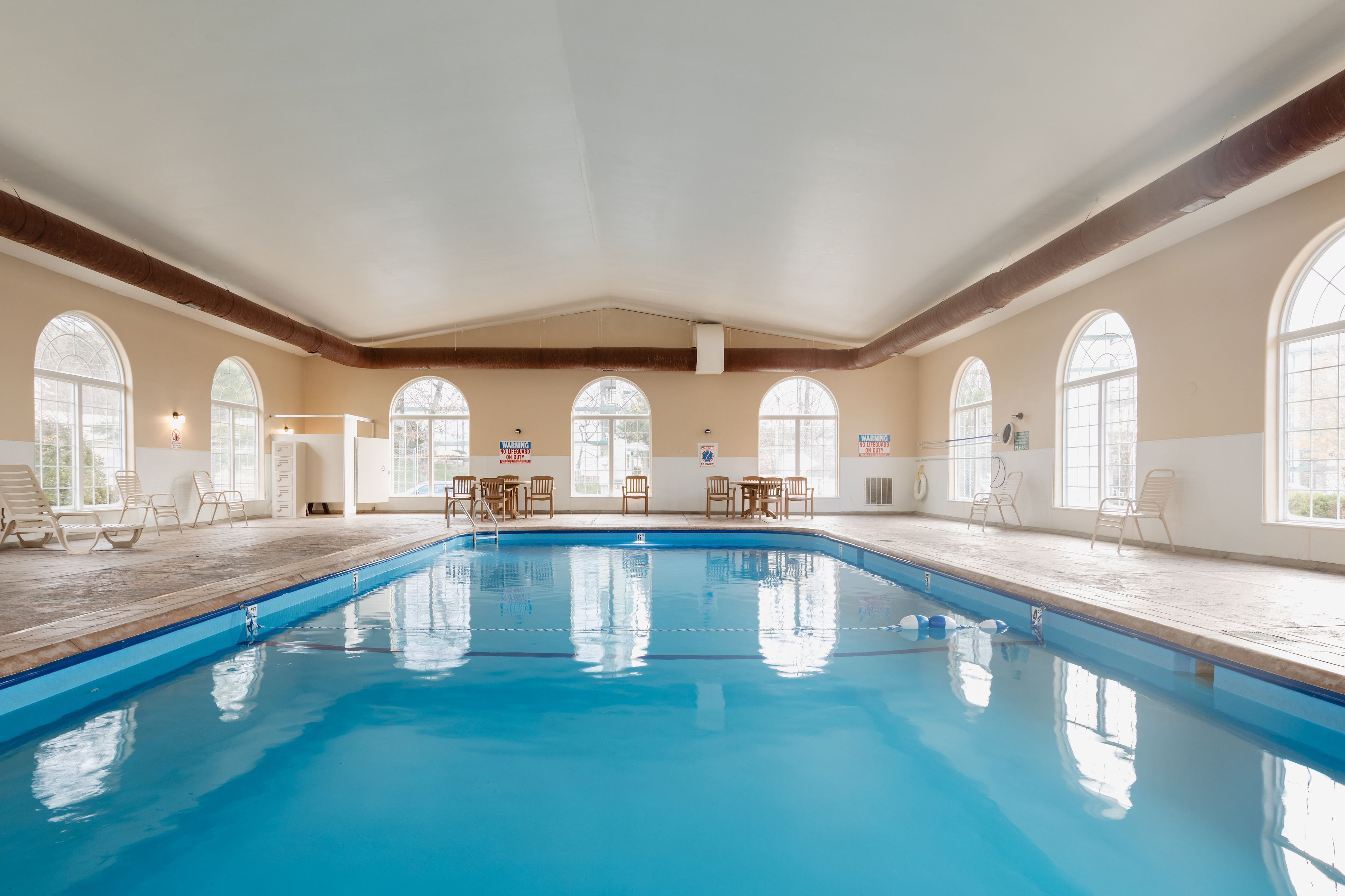 image A bright indoor pool with large windows and loungers, perfect for a calm swim or quiet break.