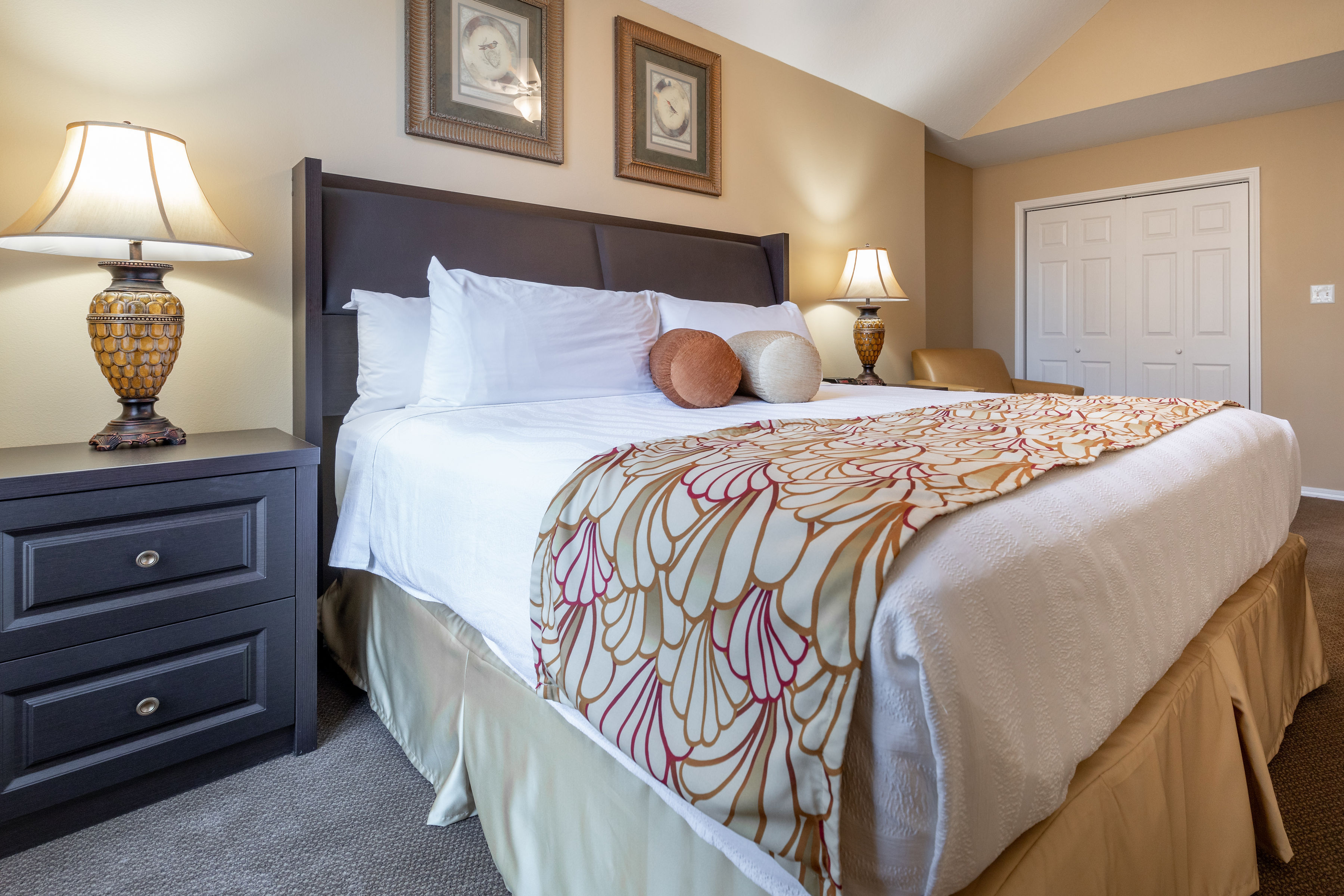 image Relax in the master bedroom featuring a plush king bed and elegant touches for a peaceful stay.