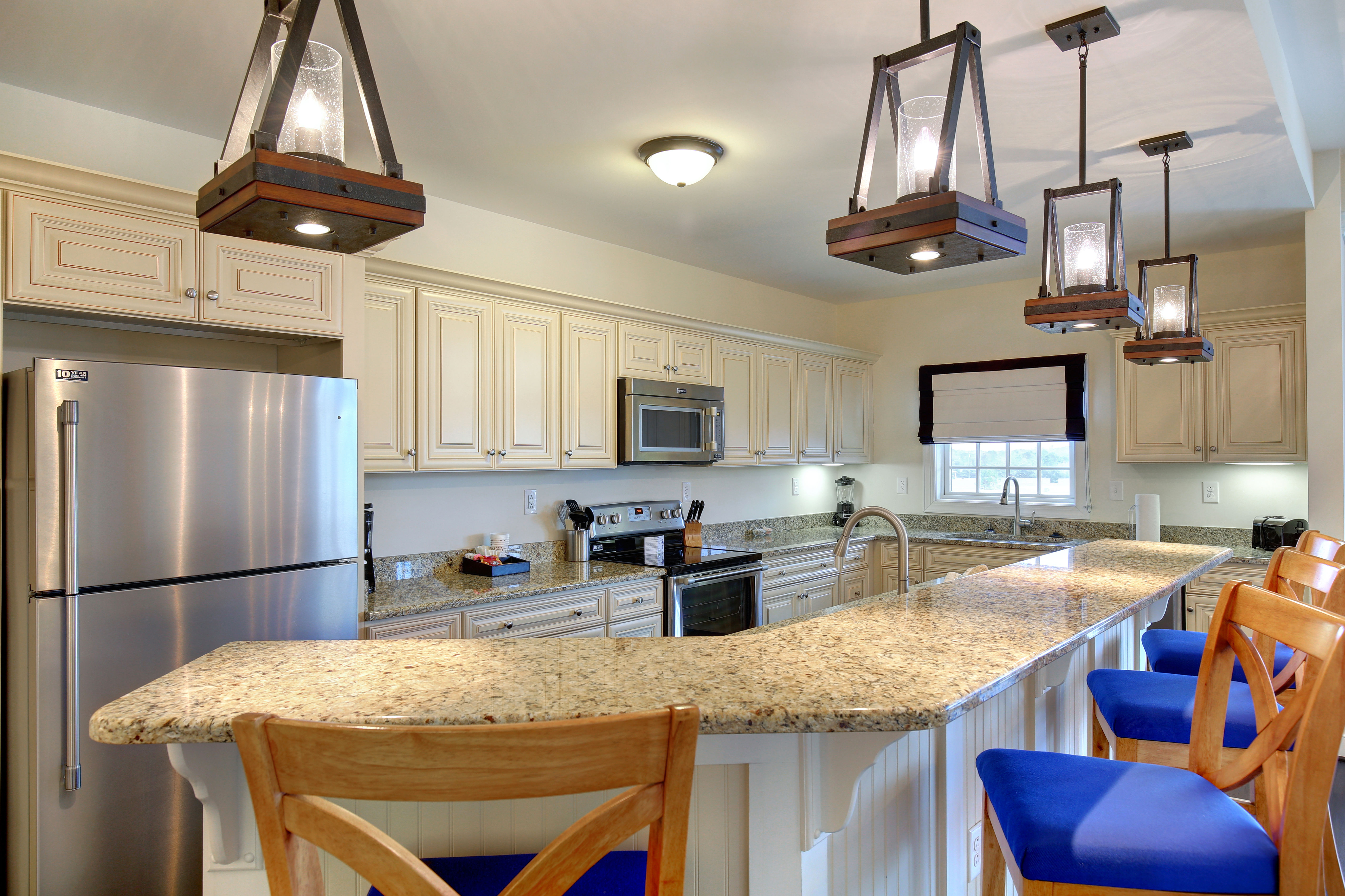 image Kitchen with stainless steel appliances and pendant lighting.