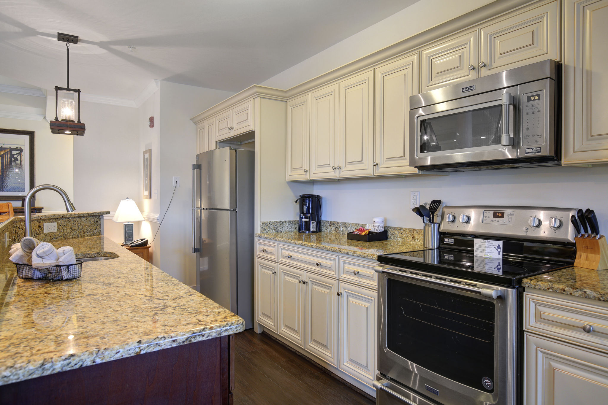 image Kitchen with cabinets, appliances, and a tiled counter.