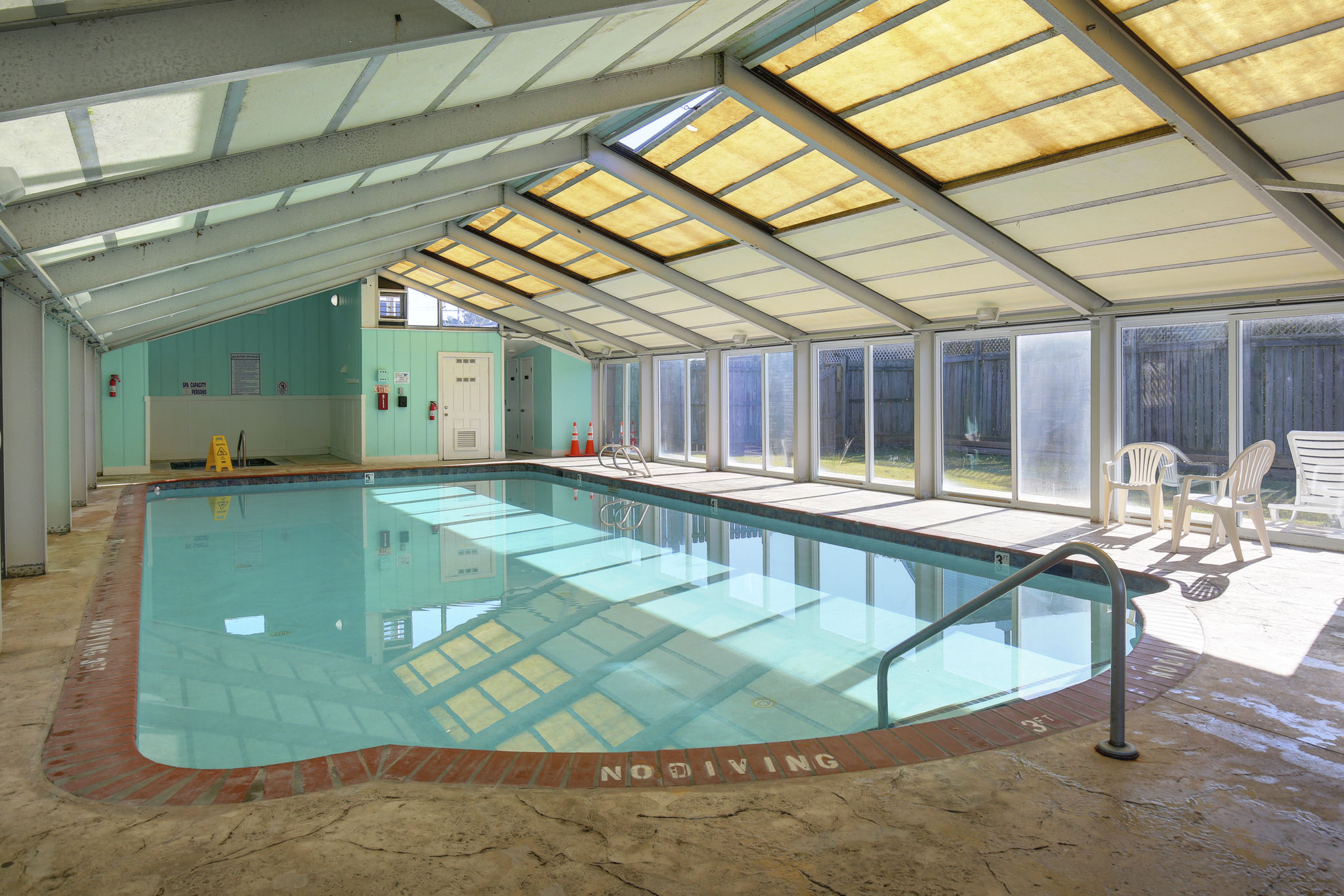image Relax in the inviting indoor pool, perfect for unwinding after a day at the beach.